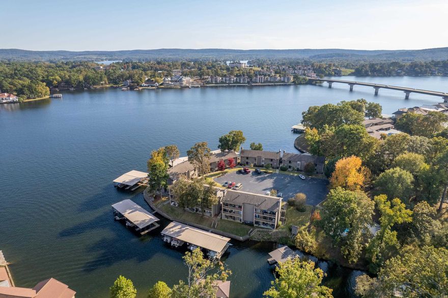 Newly renovated 2-bedroom, 2-bath walk in level condo located on the main channel of Lake Hamilton with breathtaking views up and down the lake. This open-concept unit features luxury vinyl plank flooring throughout, a spacious kitchen and dining area, and two true walk-in showers that are handicap accessible. All-new windows and doors provide energy efficiency and abundant natural light. The condo includes a one-stall covered boat slip, making lake life effortless. Community amenities include a gated entrance and tennis courts. Truly a one-of-a-kind lakefront condo in an unbeatable location.