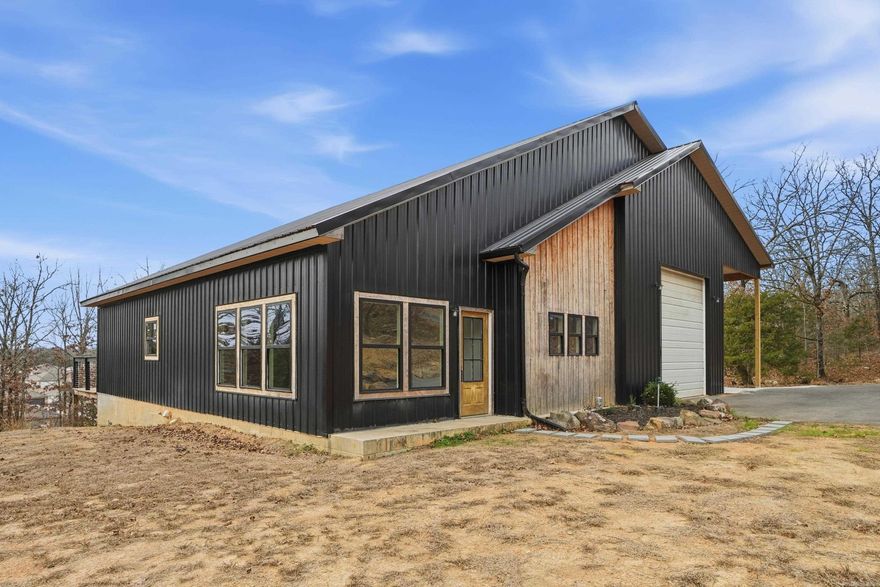 Tucked away on 3.9 mostly wooded acres, this barndominium-style home at 74 Hayes Hill Road offers the rare combination of privacy, space, and convenience—all less than 10 minutes from Conway. The home features 4 bedrooms and 3 full bathrooms, with a thoughtfully designed layout that includes potential separate living quarters—ideal for in-laws, extended family, guests, or multigenerational living. This area offers its own private exit, creating flexibility without sacrificing privacy. Inside, you’ll find generous living spaces that flow seamlessly to the outdoors. Step out onto the huge back deck, perfect for entertaining, & relaxing. The large garage provides ample room for vehicles, storage, or workshop space—well suited for both everyday living and hobbyists. Surrounded by nature yet conveniently close to shopping, dining, schools, and all that Conway has to offer, this property delivers the quiet country feel with city access that buyers are actively seeking. If you’ve been looking for acreage, privacy, and a unique home with versatile living options, this one checks all the boxes.