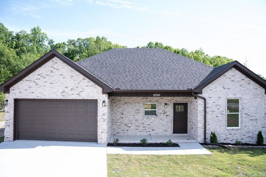 Beautiful new construction 3BD/2BA home with 1,830 sq ft! Open-concept layout with luxury vinyl flooring, tray ceilings, and recessed lighting. Kitchen features granite countertops, large island, and custom cabinetry flowing into a bright living area with sleek electric fireplace and built-ins. Split floor plan with private primary suite offering a custom accent wall with matching fireplace, jetted tub, tiled walk-in shower, double vanity, and walk-in closet. Both bathrooms feature tiled flooring. Covered back patio overlooks a huge backyard—perfect for relaxing or entertaining. Convenient location with easy access to shopping, dining, and everyday amenities. Move-in ready!