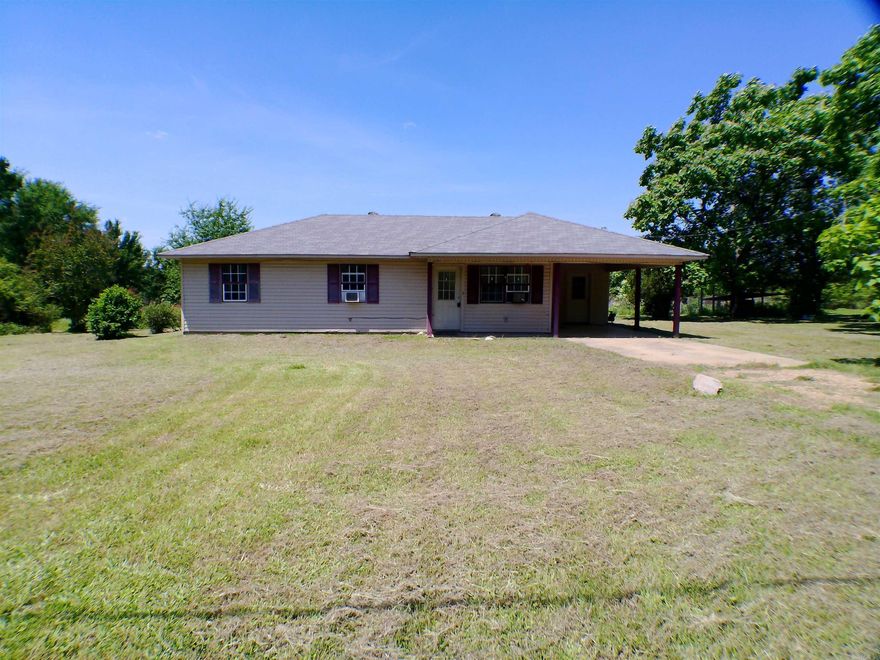 So much to love about this property and acre of land located just outside the city limits of Prescott, AR. The home site is LOVELY with a variety of trees and shrubs that bloom throughout the year and neighboring pasture land provides great privacy and wildlife watching. The home is cute with a functional layout including 3 bedrooms, 2 full bathrooms and a laundry room located off the kitchen and carport. Updates have been made in the past few years including new roof, carpets removed, concrete floors painted as well as several lighting fixtures being replaced. The potential to make this a dream first home or forever home is endless! Agents please see comments for extra information.