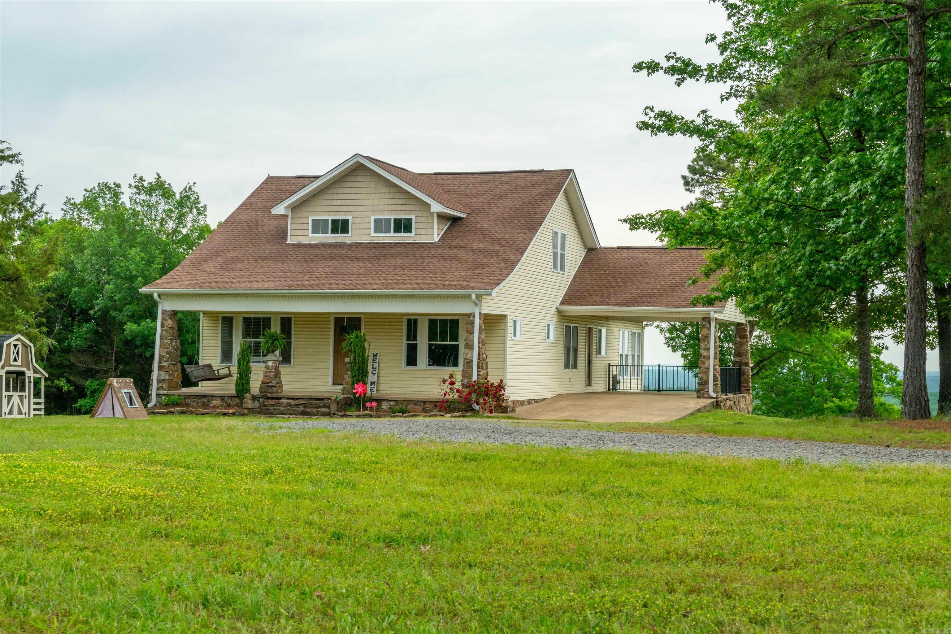 Take a look at this beautiful Craftsman-style home nestled amongst a very private 18 acres (some pasture, but more woods) with absolutely gorgeous views off the back of the home! There is no price tag to put on this stunning view! You could watch the sunrise every morning on the deck or watch from inside the huge family/sun room covered in windows on three sides! This home features a great open floorplan, two living areas, formal dining room between the kitchen and front living area, spacious kitchen with a lot of counter space and cabinetry, double oven, wood floors throughout, storm room under home & a spacious laundry room. The primary bedroom is on the main level as is another bedroom that could be used as an office with a full bath right outside. Go upstairs and you'll find a large bonus room, two bedrooms and two full baths! The crawlspace has been totally encapsulated & can be used for more storage! Agents see remarks