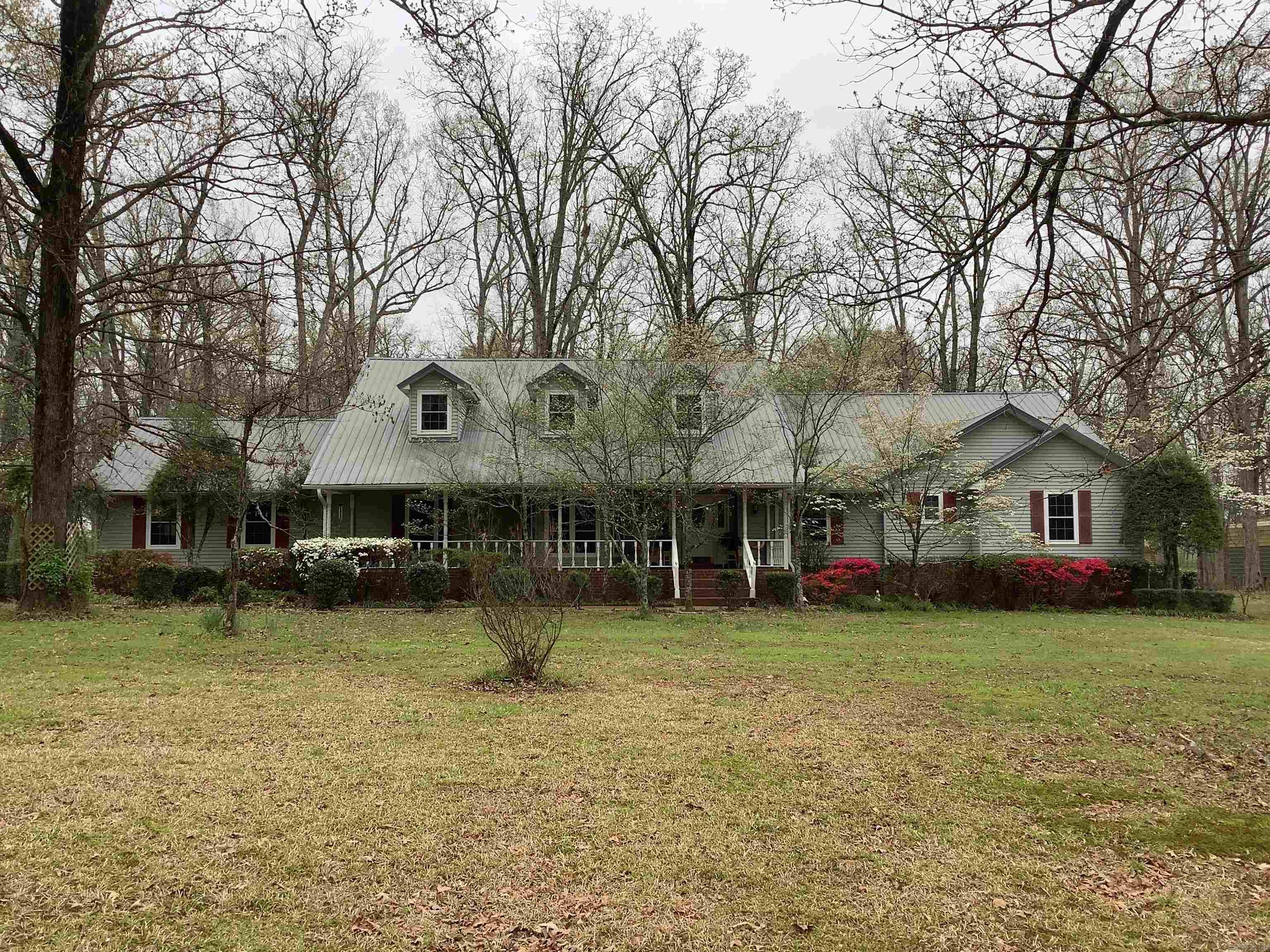 Nestled in beautiful trees is this gorgeous large home with a "quality" 2-car detached 1,110 sqft 2-bay shop/garage with storage room and extra side entrance. RV and boat awnings. You will love the huge main bedroom that is big enough for a sitting area. The main bedroom's bath has double vanities and closets on each end with large tub and separate shower in between. The kitchen has a big island in the middle and lots of cabinets and Quartz countertops along the walls. Extra wall oven in the large laundry room (with sink) off of the kitchen. Beautiful living room has a wooden tray ceiling, built-ins, and a gorgeous fireplace/mantle. Lots of crown molding throughout. Jack-N-Jill bathroom between the 2 extra bedrooms. Large breakfast nook that overlooks the huge back yard, and there is also a formal dining room. Formal living room could be used as an office. Ample storage (pantries, linen closets, extra closets) from end-to-end. Huge deck (with benches) leads into the kitchen, living room, and main bedroom. Sprinkler System (No mineral rights)