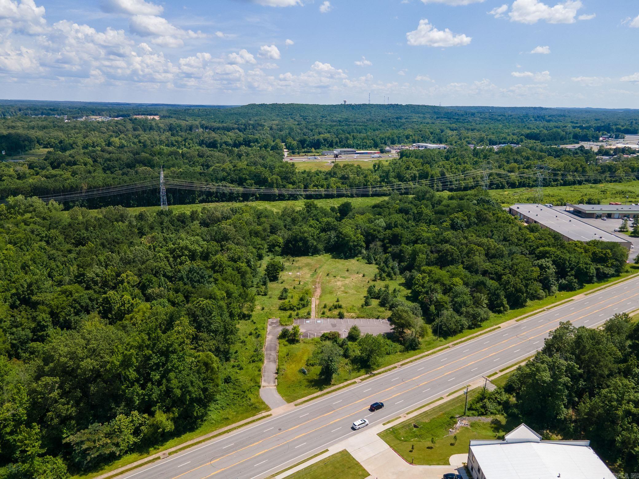 Rare opportunity to own 9.09 acres of commercial property in a high-traffic area of Little Rock. Located on Stagecoach Road (Highway 5), this property offers excellent visibility, convenient access to I-430 and I-30, and is ideally positioned for a wide variety of commercial uses. The property includes a paved parking lot, level topography, and public utilities nearby. The acreage is mostly cleared and ready for development, making it an excellent site for retail, office, warehouse, storage facility, or mixed-use projects. Zoned Commercial. Key Features: 9.09 acres of commercial land High-visibility frontage on Stagecoach Rd Existing paved parking lot Easy access to major highways Ideal for development or investment Public utilities available or nearby Don't miss this strategic investment in a growing area of Little Rock. Buyer to verify zoning, permitted uses, and utility access. Call today!