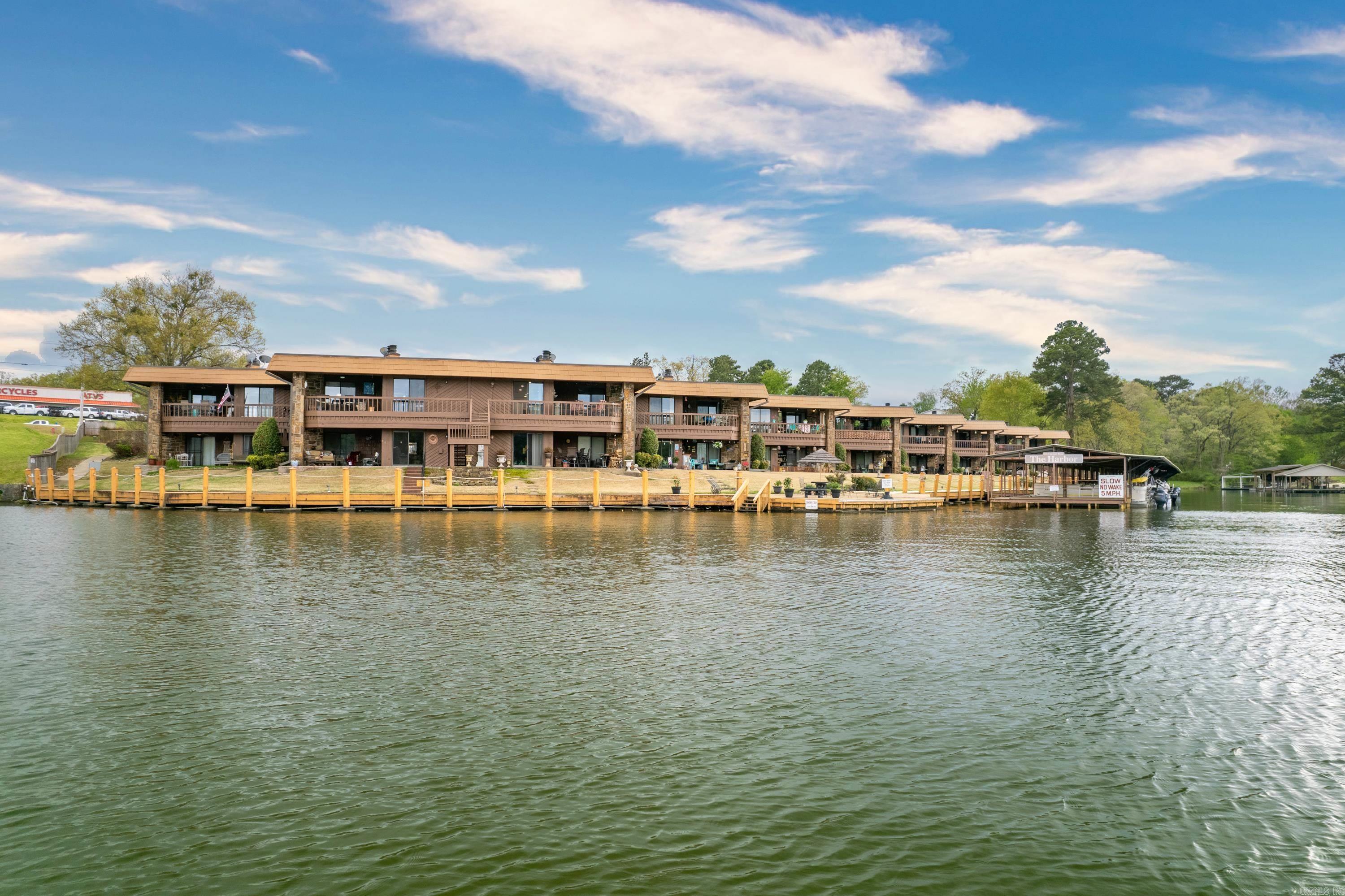 Get out of the city for a leisurely get-away. BEAUTIFULLY FURNISHED LAKE CONDO! Move in ready. Let your friends pick you up at the boardwalk for a Lake Hamilton fun day of boating! Located just off of main channel and only minutes from the bypass. Gated entrance. Privacy fenced. This ground floor unit has been renovated with style, a perfect fit for lake living fulltime or parttime. Kitchen has granite countertops and beautiful cabinetry. Ample closet space. Immaculate grounds, inground pool, wood burning fireplace. Picnic area, swim platform and boat tie ups. Furniture conveys. No seller's disclosure available. Three month minimum unit rental. Boat slip at property may be available to lease. PRICED TO SELL!