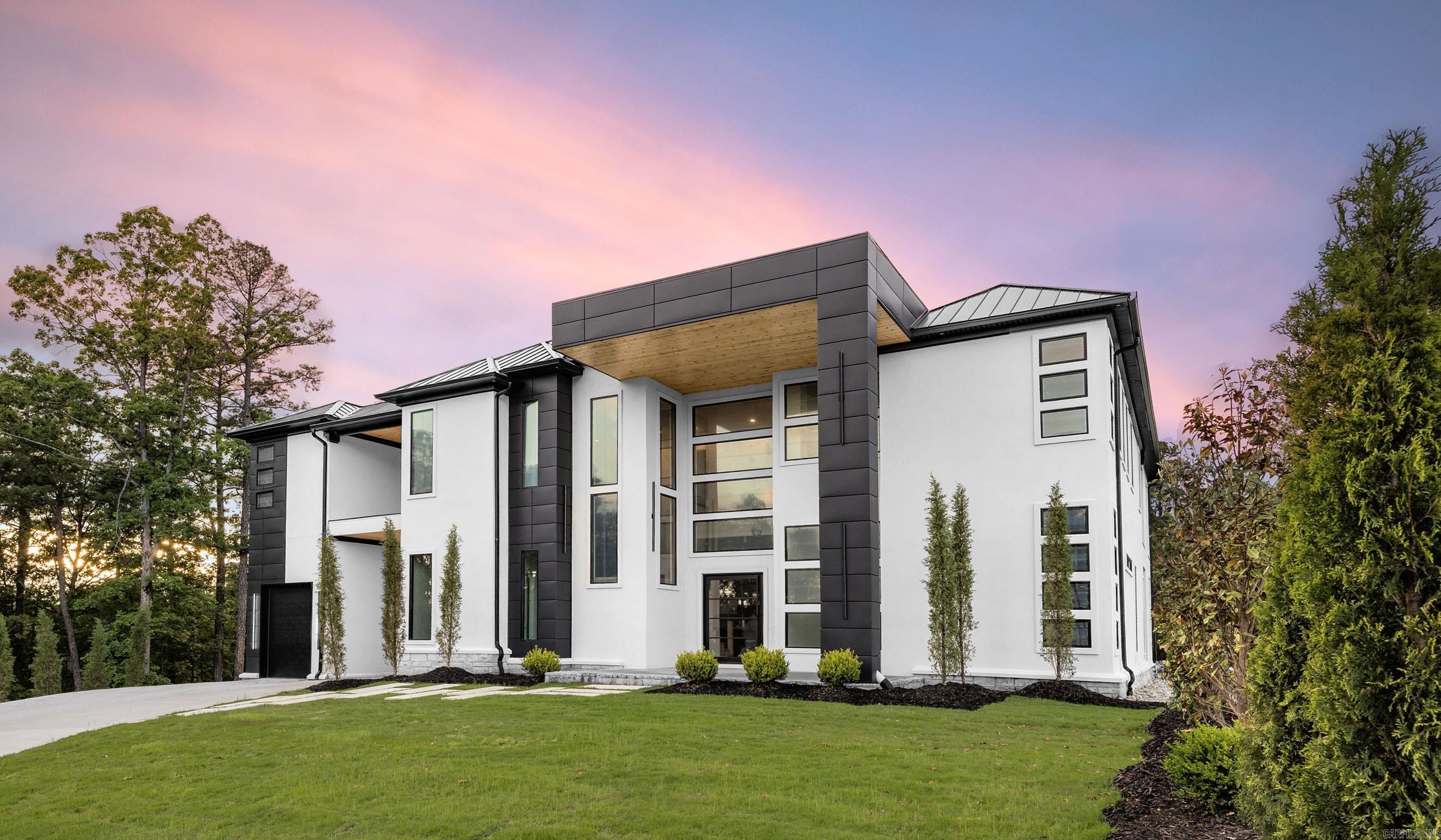 EXQUISITE MODERN LUXURY! Surrounding this gated spread is a custom designed LUXE POSH residence located in prestigious Chenal & sprawls large cul-de-sac property & nearby Chenal Country Club! Prepare to be captivated by the striking allure of this jaw-dropping, one-of-a-kind design, boasting expansive floor to ceiling windows & open concepts truly EXCEPTIONAL & BREATHTAKING! Exceeding all expectations, this estate features stone walls, luxury lighting w/a dynamic & intricately handcrafted chandelier & exotic waterfall stone tops! Multi-car garages are temp controlled (10' openings) & private courtyard w/added parking, a fitness center w/wet bar/fridge & serene views from a private balcony! Nearby theatre is flanked by designer walls flaunting unique lighting! The builder incorporated the use of "raw" & "natural" materials such as iron, stone, glass, wood & steel while seamlessly blending high ceilings & an abundance of natural lighting! Secondary kitchen offers excellent entertaining space, private balcony! Master suite possesses stone wall features, an indulging & lavish dual massaging shower, private patio & FP! High-end prime kitchen & Scullery! Pool worthy! Immeasurably more!