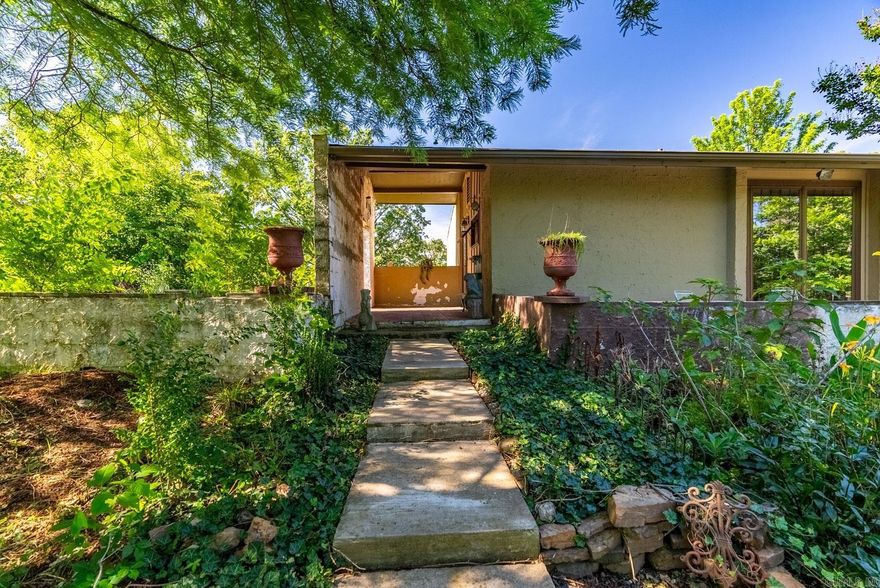 A UNIQUE OPPORTUNITY ON CONWAY CORP!   Check out this one-of-a-kind, spacious property that has a shop and is ready for your creativity. Drive up to the house and be surrounded by nature and a variety of plants and trees. Walk up the stone path and enter into a large living space with vaulted ceilings and a wood-burning fireplace. From the living room, you can walk out onto your enormous deck that has a nice view off of the mountain in the fall and winter. A guest bedroom with half bath is on the main level off of the living room, and the kitchen is also located on this level. Plenty of cabinet and countertop space with a small pantry. The lower level features two bedrooms with private, full bathrooms, a craft room/office, and the laundry room. There's a small courtyard at the front of the house that leads into a bright sunroom/breezeway. You'll love all of the room in the two-car garage, and it has two storage rooms as well. Peach and fig trees are at the back of the property. Washer and dryer convey with the property. No seller's property disclosure. This house cannot go FHA, VA, or USDA-RD (see remarks for info).