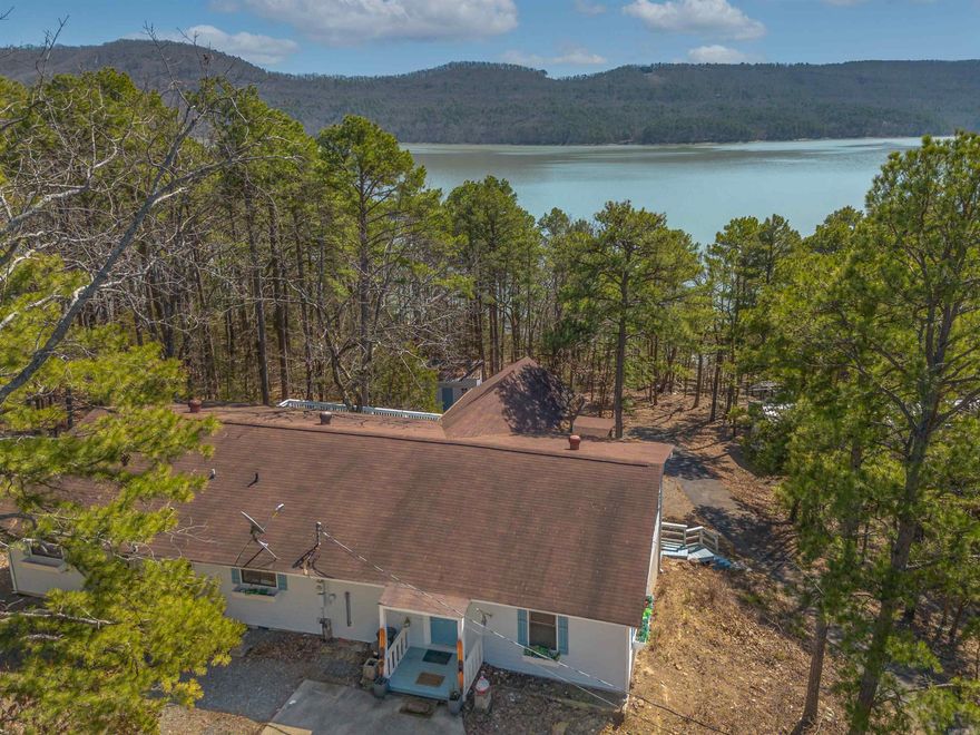 Welcome to your Lake Front oasis in coveted Emerald Cove Subdivision, just a stone's throw from the crystal-clear waters of Greers Ferry Lake. Nestled in the heart of the Ozark Mountains, this beautifully updated property offers the perfect blend of luxury, comfort, and nature.  The main home features a gorgeous kitchen designed with entertaining in mind, complete with modern finishes and an open layout. The incredible primary suite offers a true retreat, with spa-like features and thoughtful details throughout. Gather with loved ones in the incredible dining area—a space designed for making memories that last a lifetime.  Multiple spacious decks and a cozy fire area invite you to relax and soak in the mountain air.  Also included is a charming guest house, perfect for visitors or rental income potential—this property has a proven track record as a nightly rental.  Just a one-minute drive to the neighborhood boat launch, and a short stroll to the lake, your outdoor adventures are always close at hand. The game pavilion with a hot tub is the ultimate entertainment spot for friends and family.  Whether you're looking for a private residence, vacation home, or investment opportunity,