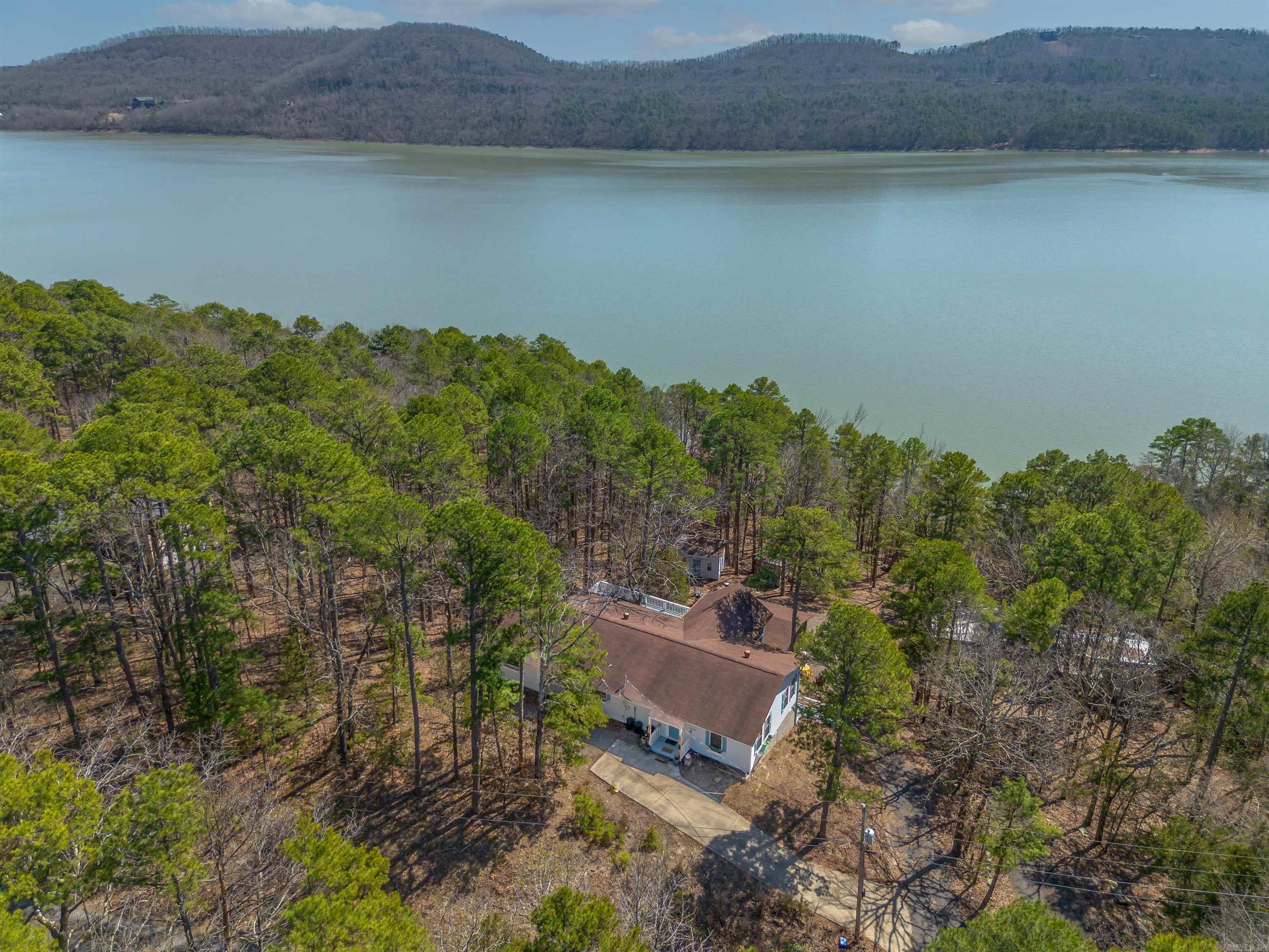Welcome to your Lake Front oasis in coveted Emerald Cove Subdivision, just a stone's throw from the crystal-clear waters of Greers Ferry Lake. Nestled in the heart of the Ozark Mountains, this beautifully updated property offers the perfect blend of luxury, comfort, and nature. The main home features a gorgeous kitchen designed with entertaining in mind, complete with modern finishes and an open layout. The incredible primary suite offers a true retreat, with spa-like features and thoughtful details throughout. Gather with loved ones in the incredible dining areaāa space designed for making memories that last a lifetime. Multiple spacious decks and a cozy fire area invite you to relax and soak in the mountain air. Also included is a charming guest house, perfect for visitors or rental income potentialāthis property has a proven track record as a nightly rental. Just a one-minute drive to the neighborhood boat launch, and a short stroll to the lake, your outdoor adventures are always close at hand. The game pavilion with a hot tub is the ultimate entertainment spot for friends and family. Whether you're looking for a private residence, vacation home, or investment opportunity.