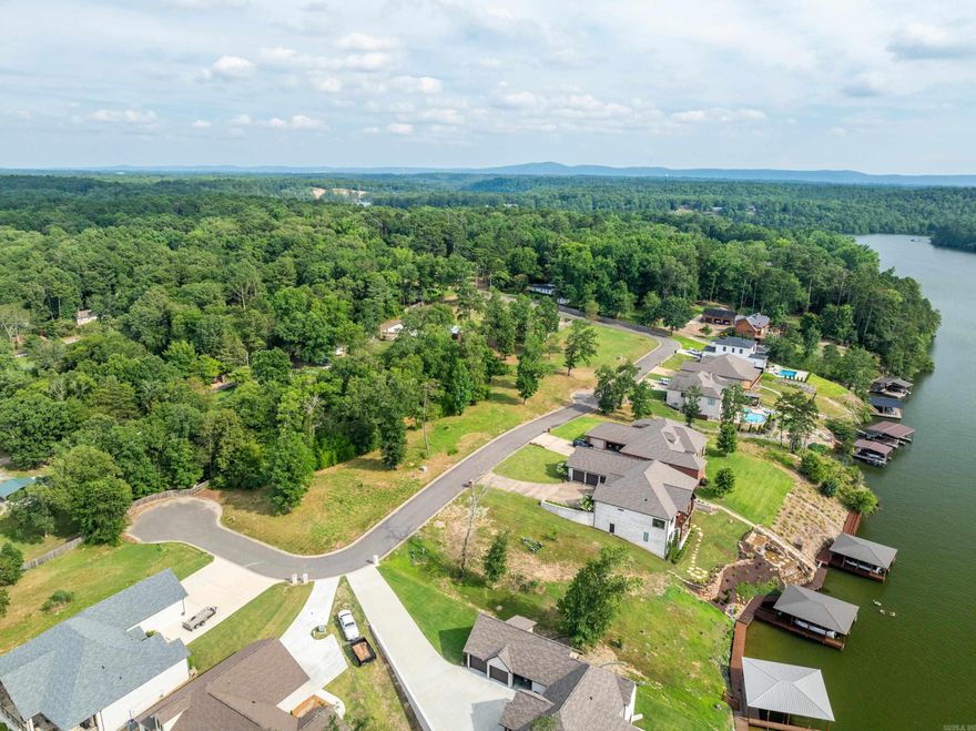 Tucked behind the gates of Oak Ridge Lake Estates lies a rare opportunity—one of the last untouched lots overlooking Lake Hamilton, where golden sunsets spill across a panoramic view. Just a minute from Hwy 270, with effortless access to both Lake Hamilton and Lake Ouachita, you’re perfectly positioned for double the adventure, serenity, and investment potential. The views are big, the vibe is elevated, and the timing couldn’t be better—before everyone else discovers it. Community boat ramp for lake access.