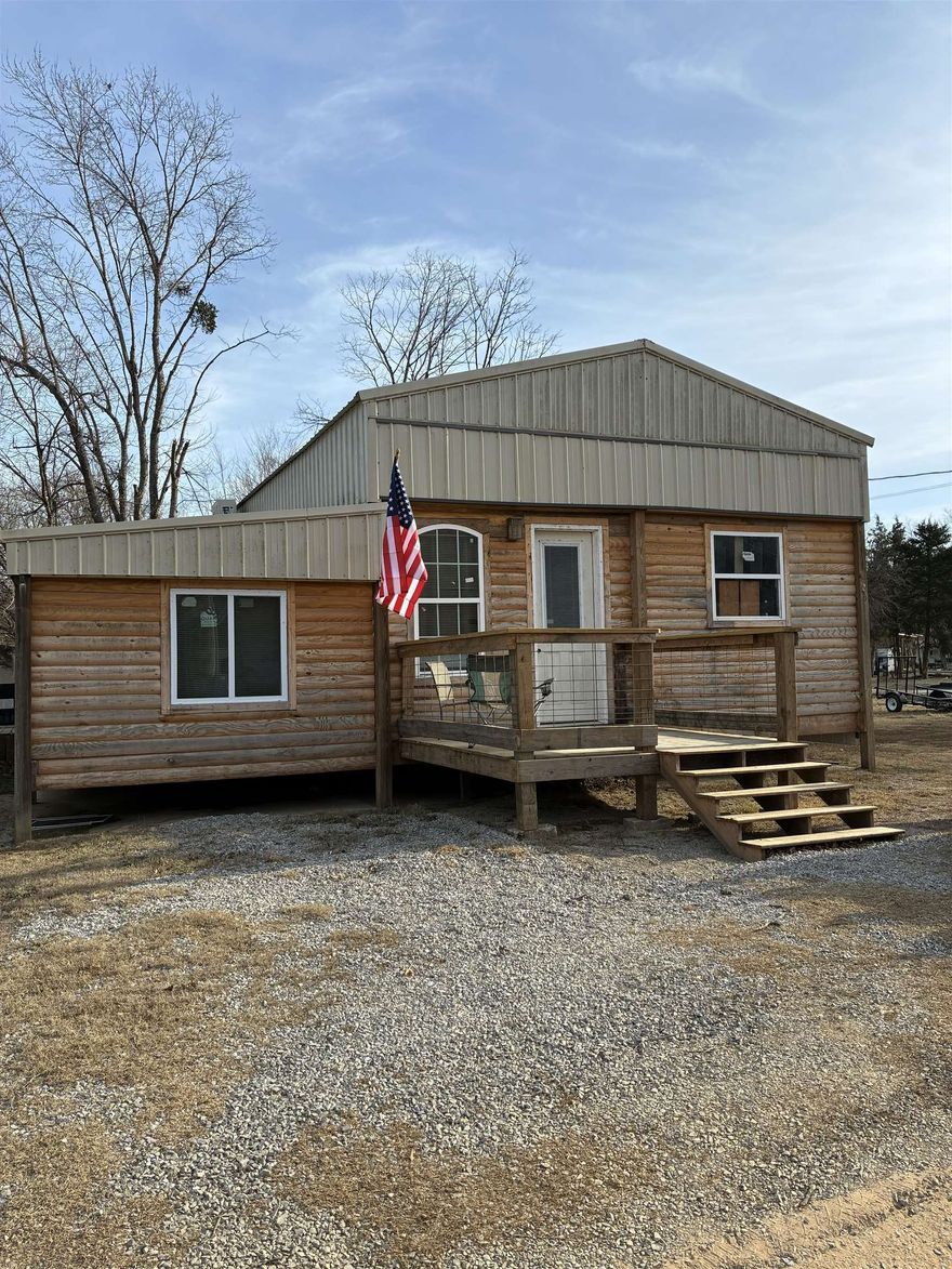 Rustic Cabin Getaway Near the Spring River!  This charming 1-bedroom, 1-bath cabin is a work in progress—but you’ll be pleasantly surprised by how much has already been done! The home features a full bathroom with an apartment-sized washer and dryer, and there’s an unfinished bonus room that could serve as a second bedroom or extra storage space.  Enjoy the outdoors on the back porch with a built-in outdoor kitchen, or relax around the firepit under a beautiful pergola. The property includes three lots plus a 2018 camper with 2 pullouts that can be used for additional guest space.  The cabin’s log siding and rustic interior finishes give it a warm, vacation-home feel. This secure, gated community features gated access and numerous amenities, including two in-ground swimming pools, bathhouses, playground, and yearly activities to enjoy, such as music and fireworks.  Annual dues ensure most of the work is done for you (even pump service) - you just come and enjoy the beautiful Spring River! There is a community lot of access to the Spring River.   Don’t miss this opportunity to make it your own slice of paradise!