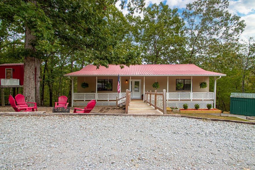 Welcome to this beautifully updated home on a peaceful, quiet road. Step inside to a tiled foyer with luxury vinyl flooring throughout. The kitchen features oak cabinets stained a beautiful dark hue and a Vent-A-Hood venting directly through the roof. This all-electric home includes a finished walk-out basement with a large laundry room, utility sink, and a spacious 2-car garage. The basement also includes an additional den and one of the three bedrooms. Built with durable 2x6 exterior walls, this home offers strength and efficiency.  A circular driveway leads to the front, with a separate driveway offering access to the side-entry garage. Outside, enjoy an approximately 18x20 storage building with a loft, plus a playhouse with electricity that the seller is willing to leave behind. Relax on the covered front and back porches, with direct access from the master bedroom to the back porch.  Other updates include all new electrical and plumbing, and a 26-gauge commercial-grade metal roof installed approximately 6 years ago. This home blends modern features with ample space inside and out, making it perfect for comfortable living.