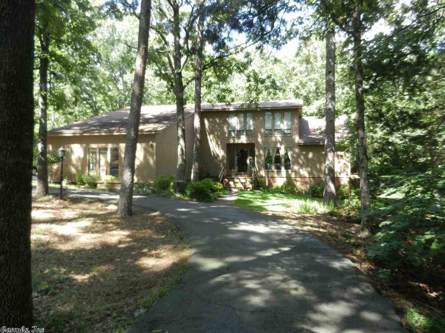 Winding drive leads to Rustic home on 3+acres in center of cul-de-sac. HUGE master w/brick WBFP on main level. Master bath w/sep. tub & shower, walk-in-closet. Office on main level. 2 br & bath up w/balcony overlook. Windows  along back reveal expansive view of trees. Sun porch. Soaring ceiling in sunken great room & floor to ceiling rock WBFP surrounded by blt-ins. Rock wet bar. Large kitchen w/breakfast area & separate dining. Wrap around Deck. Updated A/C down w/1 yr. war. Fridge, dryer NEW Washer stay