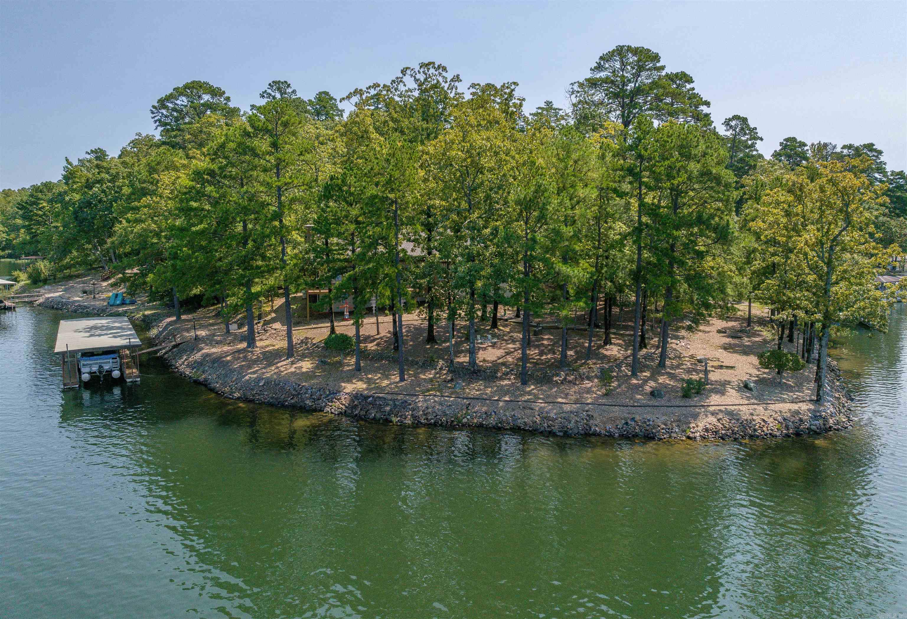 WOW! Lake Cortez PREMIUM Lot - 320' of WATERFRONT on over an acre! This Oasis can be yours, with more than 180 degree water views! This "Atrium" floorplan by Cooper boasts High Ceilings, Rich Updated Flooring, and a Gas Fireplace in the Living Room! The Primary Bedroom with Vaulted Ceiling and 2 Walk-in Closets, opens to the Ensuite with Jacuzzi Tub & Walk-in Shower! The Kitchen with Eating Bar offers a cute Bay Window Eating Area. The 2 Car Garage enters to the Laundry & Half Bath for convenience. 2 Guest Bedrooms are separated for privacy, (one with a slider to the courtyard) and full hall bath. The Living/Dining Rooms are great for entertaining with a Wet Bar and access to the Entertainment-sized Deck! Below the Deck is a Shop/storage Room (aprox 20x12?). A Whole-house Cummins Generator and 500 gal in-ground Propane Tank insures you will be warm in any circumstance! The in-ground Sprinkler System is set up to draw from the lake! The insulated water line from the street to the house was recently replaced (2' underground)! Class 3 "impact resistant" Architectural Roof is 2years old! (Skylight just replaced). Water heaters are 3 mos old. HVAC 10 years (serviced every 6 mos!)