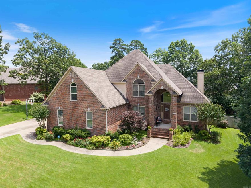 This classic brick home offers timeless curb appeal, manicured landscaping, and a light-filled interior with a spacious, thoughtful layout. The entry opens to a two-story ceiling and leads to a formal dining room and private office with French doors and built-in bookcases with shelving. The great room features a wood-burning fireplace, arched windows, and built-in bookcases with shelving. The great room is open to the kitchen featuring a granite island, gas cooktop and new smart appliances (in 2020-2022) including double ovens, microwave, dishwasher and refrigerator. The main-level primary suite offers a tray ceiling, seating area, and spa-like bath. Upstairs includes a game room, guest suite, and two additional bedrooms with a hall bathroom. Enjoy outdoor living with a new wood deck, flagstone patio, firepit, and privacy fence. Additional features: new Pella windows, interior paint, laundry room with utility sink and a three-car garage.