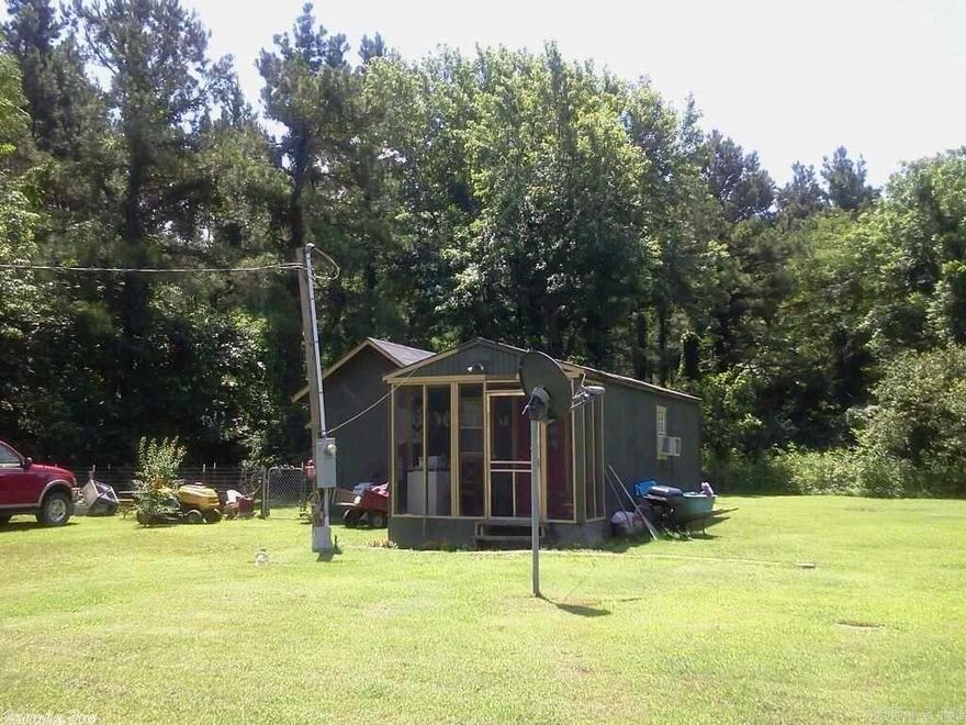 3 Wonderful lots complete with approx 592 sq feet of living quarters, and 40 foot storage container  (complete with lights and power).. Right across the street from the Little Red River!!  Excellent hunting and fishing and it IS NOT in a Flood plain!!   Cottage on property is fulling livable. One bedroom one bath, stove, internet,cable. Fenced back yard for pets.This is the perfect place to live while you build a home and then still have full in-law quarters. Dont let this Hunting/Fishing Paradise get Away!