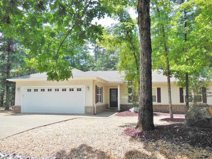 Contemporary Home - LIKE NEW!  Charming high ceiling living areas complimented by a gas-log fireplace & archways, plus an open, split bedroom plan make the inside of this beautiful home as appealing as its professionally landscaped front yards outside.  Ready for you to move & enjoy the great amenities offered: laminated wood floors, Corian counter & decorative cabinetry, crown-molded coffer ceiling in master suite, large step-in shower, walk-in closet, covered deck & brush-nickel fixtures .... Come see!