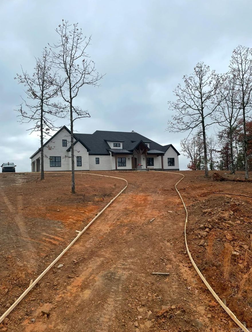 This home features a custom designed open floor plan with completely custom finishes. Large windows highlight the view of Lake Maumelle, large outdoor space with custom built outdoor kitchen.