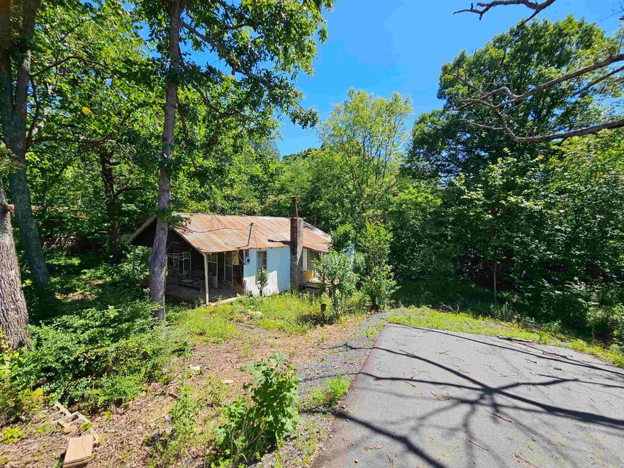 1.47 acres directly on HWY 65! This property is mostly wooded with two paved driveways for direct access from Hwy 65. The barn on the property has a concrete slab, great for storing your extra side by side, RV, or a workshop!  Call to see today! DO NOT ENTER THE PRIMARY RESIDENSE ON THE PROPERTY IT IS UNSAFE.   If you have to at some point have access to the residence all agents and buyers will have to 1st sign a hold harmless.  This is mandatory