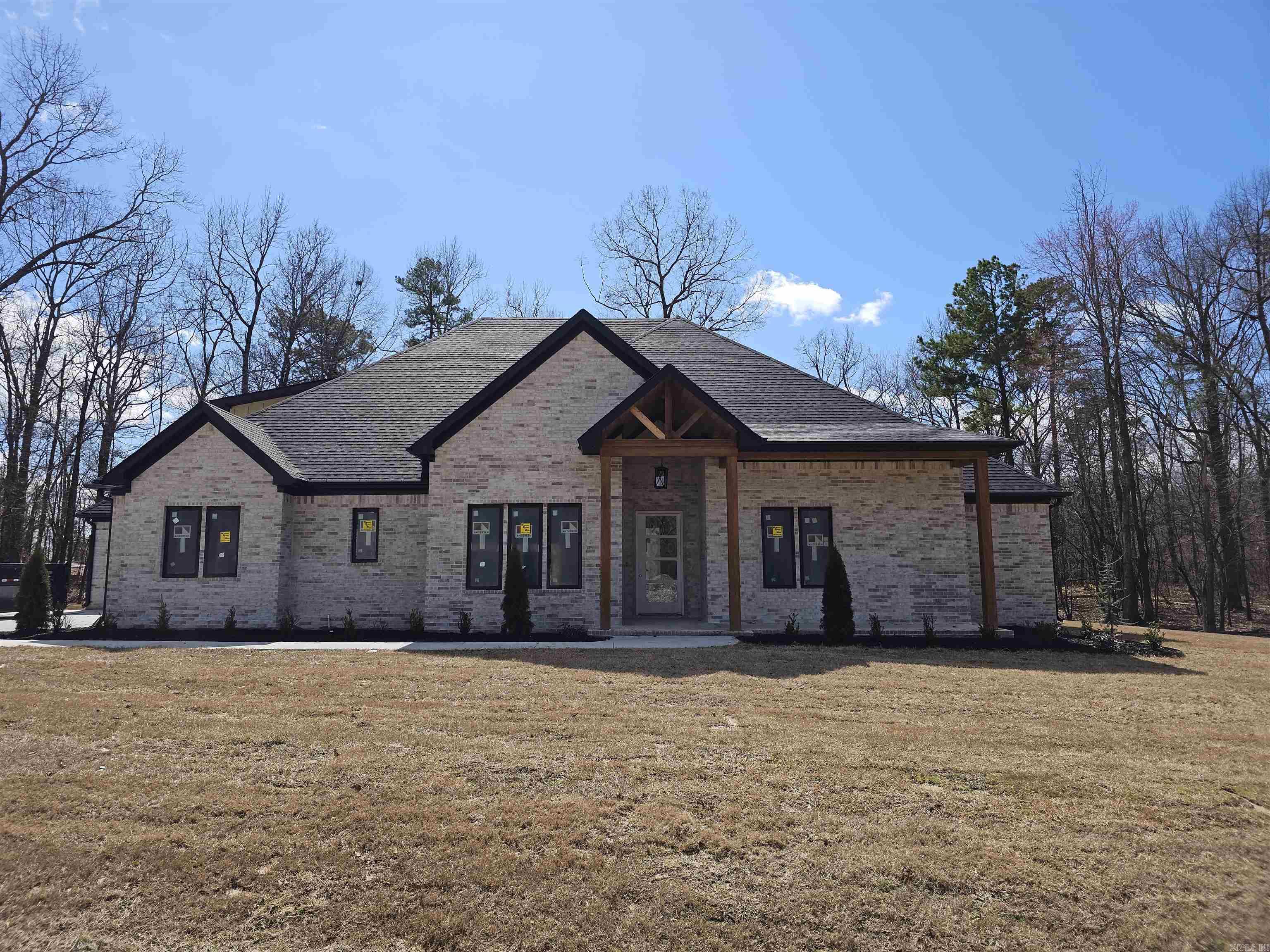 This 3433 SqFt home features 5 bedrooms and 4.5 bathrooms, enveloped in coziness with Low-E casement windows that gently invite natural light, while 12ft ceilings in the kitchen and a vaulted ceiling in the living room create a plethora of space in the main areas. The warm embrace of 10ft ceilings downstairs sets the perfect ambiance, accompanied by gas logs in the living room and a rustic wood burner on the porch. The master suite features a walk-in shower, while an inviting in-law suite and two bedrooms accompany the lower level. Upstairs features a captivating bonus space. This home also offers wood flooring throughout, an acre wooded lot, and a 3-car garage.