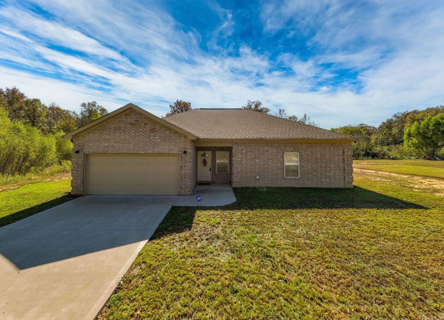 Like-new and full of charm! This 2022 beauty sits on a full acre in a quiet country setting — the perfect blend of peaceful living and modern style. Inside, you’ll find thoughtful upgrades at every turn: custom window shutters, granite countertops, and a cozy fireplace that anchors the open living space. The kitchen is a showstopper with elegant cabinetry, a wall oven and microwave, and a surface range — ideal for anyone who loves to cook...or just wants to look like they do! The spacious owner’s suite offers a spa-like retreat with a soaking tub, walk-in shower, double sinks, and a dreamy closet with built-ins. On the opposite side of the home, two more bedrooms, lots of storage, and a full bath provides space for family, guests, a home office, or whatever your needs may be. Step out back to a covered porch made for sunsets and slow evenings. Located in an RD Loan eligible area! Country quiet meets modern comfort — come fall in love!