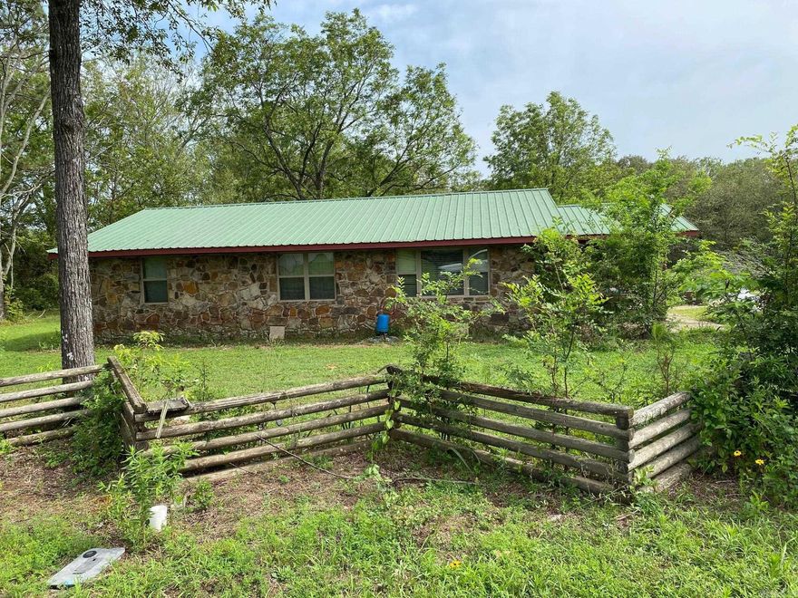 Home with 40 acres, multiple sheds and pens.