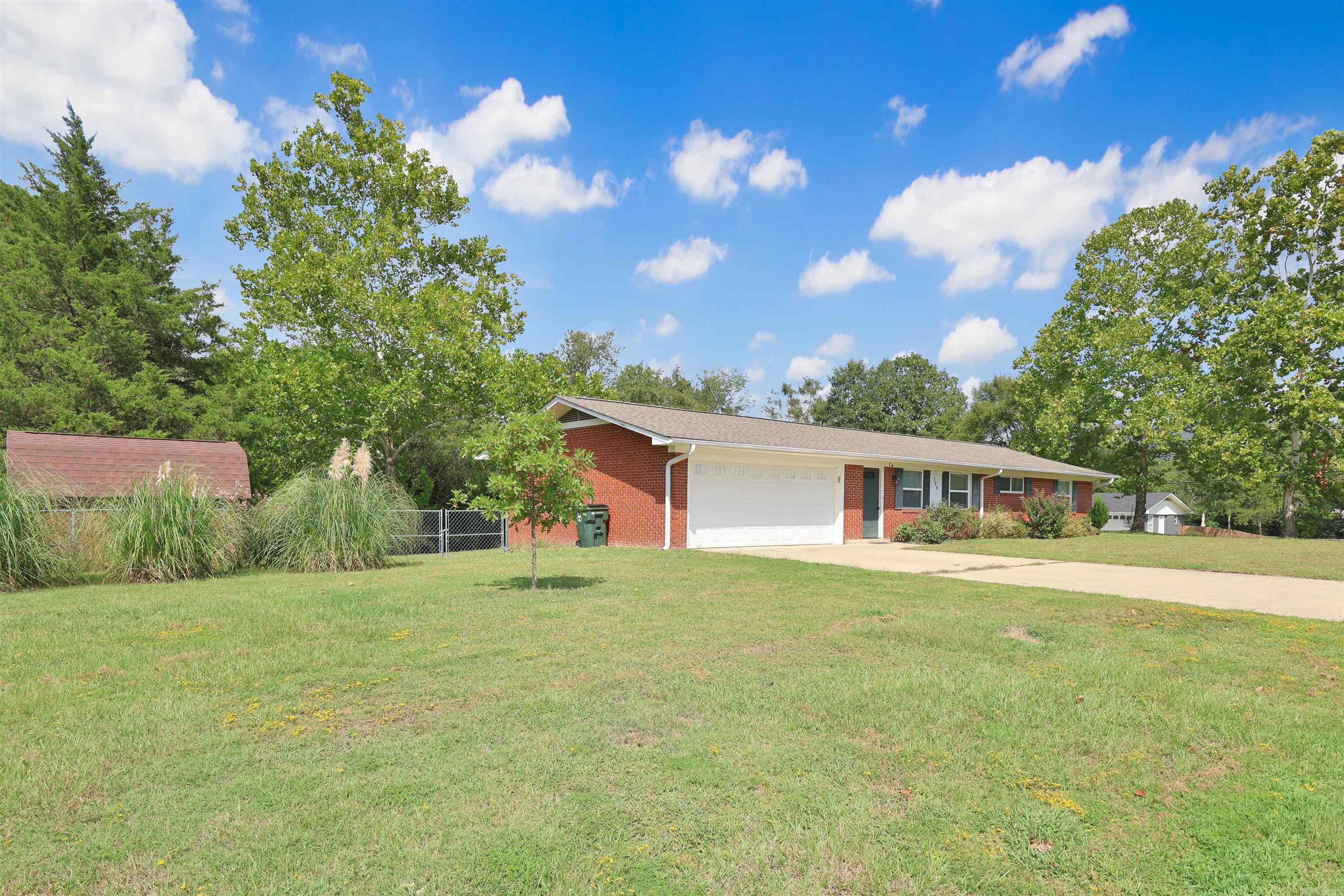 Welcome home to comfort, convenience, and just the right amount of charm. The updated brick home sits on a spacious corner lot over half an acre. Step inside to find a layout designed for everyday living that includes three bedrooms and two full baths with easy to maintain floors (no carpet) flowing from room to room giving each room a clean and modern feel. The primary bedroom features an en suite bath with dual sinks to simplify your morning routines. The dining area comes complete with charming French doors that lead out to a covered back porchāperfect for sipping morning coffee or hosting weekend barbecues. The fully fenced backyard offers plenty of room for kids, pets, and thereās even a shed for your tools & toys. Recent updates include a new H&A system, and the attached two-car garage provides secure parking and additional storage space. Located close to conveniences like shopping, restaurants, medical, RV resort, and public transportation. Whether youāre settling down or setting out on a new chapter, this home is ready for you to write your story. For added convenience the refrigerator and shed will convey, making your move a bit easier. Schedule your private tour today!