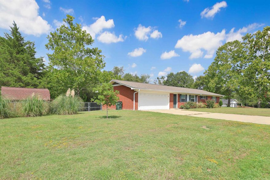 Welcome home to comfort, convenience, and just the right amount of charm. The updated brick home sits on a spacious corner lot over half an acre. Step inside to find a layout designed for everyday living that includes three bedrooms and two full baths with easy to maintain floors (no carpet) flowing from room to room giving each room a clean and modern feel. The primary bedroom features an en suite bath with dual sinks to simplify your morning routines. The dining area comes complete with charming French doors that lead out to a covered back porch—perfect for sipping morning coffee or hosting weekend barbecues. The fully fenced backyard offers plenty of room for kids, pets, and there’s even a shed for your tools & toys. Recent updates include a new H&A system, and the attached two-car garage provides secure parking and additional storage space. Located close to conveniences like shopping, restaurants, medical, RV resort, and public transportation. Whether you’re settling down or setting out on a new chapter, this home is ready for you to write your story. For added convenience the refrigerator and shed will convey, making your move a bit easier. Schedule your private tour today!