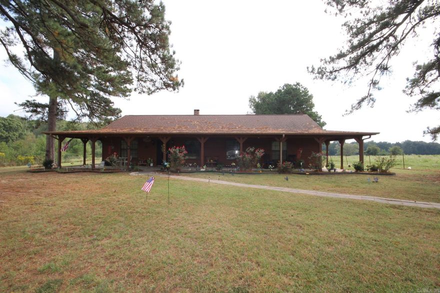 3 Bedroom, 2 full baths with approx. 1628 Sq. Ft. of living space situated on approx. 1.80 acres.  Kitchen has great storage space, granite counter tops, knotty pine vaulted ceiling and pantry (Dishwasher, range, microwave and refrigerator conveys).  Family area features a massive wood burning fireplace and knotty pine vaulted ceiling.  Home has a wrap around covered porch.  Property has a concrete slab with water ready to build your shop on.