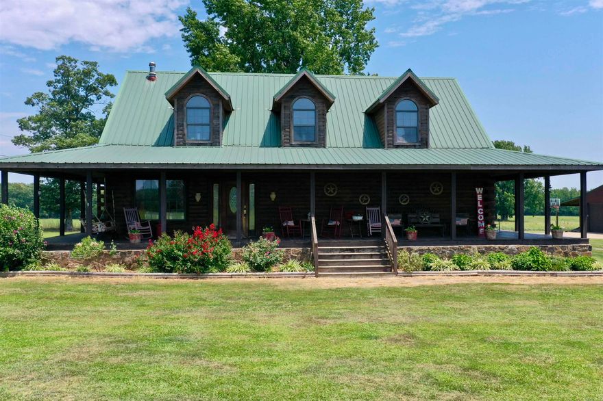 Take a look at this log home on a quiet 11 acre tract, offering amazing sunsets. This property boasts a 30x40 shop complete with electricity and a lean-to on each side, providing ample space for all your hobbies and projects, equipped with an RV hookup. Enjoy the summer days by the above-ground pool with a spacious deck perfect for entertaining. The wrap-around porch invites you to relax and savor the tranquility of your surroundings. 2574 sq ft of living space with 3 bedrooms and 2.5 baths, there's plenty of room for everyone. The versatile loft area can be utilized as an extra den, living area, loft bedroom, office, or gameroom catering to your unique needs. The primary-suite is conveniently located on the main floor and features an additional office/craft room/nursery that adjoins. The two guest bedrooms on the second floor provide ample space for family or guests. A well-appointed walk-in pantry, gas range and extra cabinetry complements the kitchen. This home offers indoor access through the primary-suite closet to the large safe area providing safety during emergencies or extra storage space. Schedule your showing today.