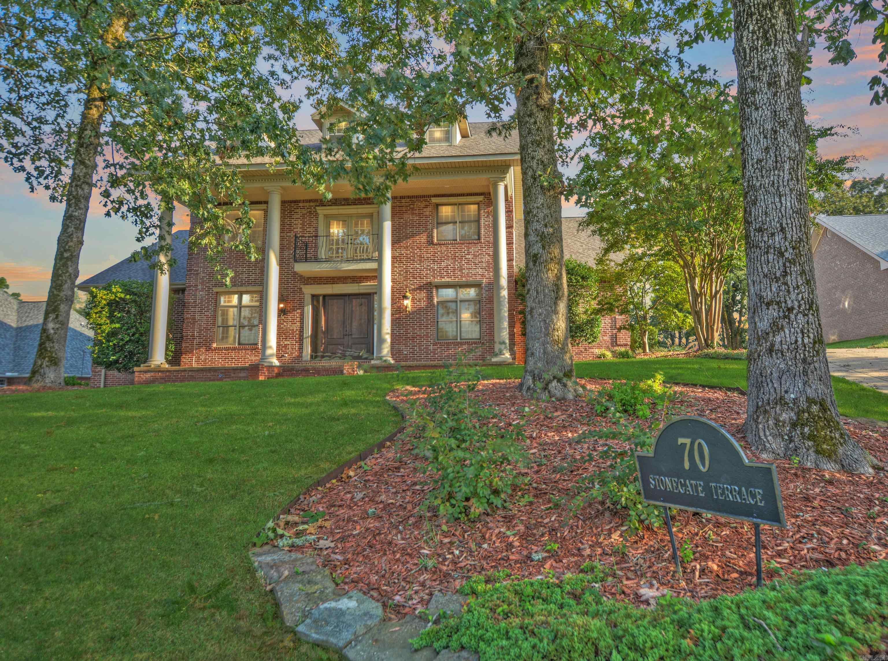 Elegant 4,320 sq. ft. Colonial in the coveted Stonegate neighborhood on Lake Hamilton. This three-story brick estate offers lake and mountain views, a main-level primary suite with fireplace, chef’s kitchen, formal living and dining, and custom storage throughout. Upstairs features three bedrooms plus a large bonus room and Juliette balcony. Includes a detached three-car garage, new deck, and an assigned covered boat slip. Stonegate amenities include gated entry, clubhouse, pool, courts, and boat ramp.