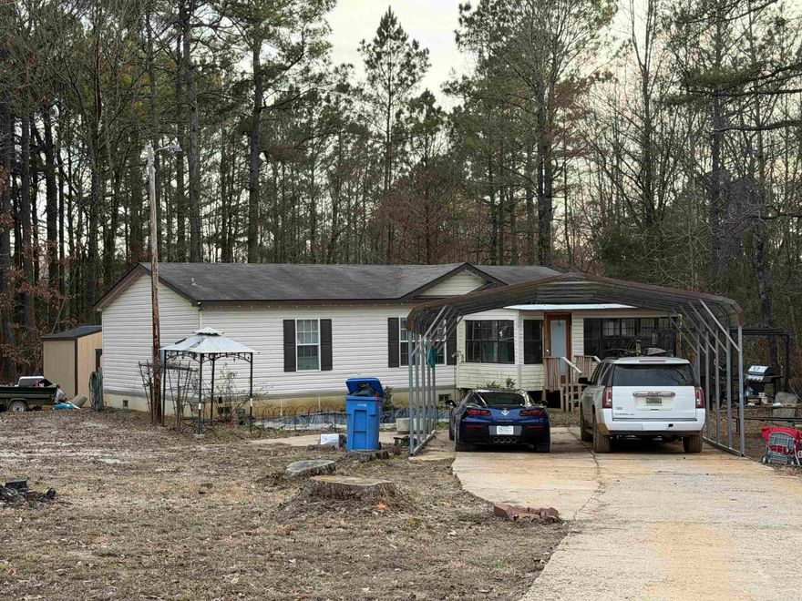 Looking for country living?  This 3 bedroom, 2 bath manufactured home offers 1,344 sq.ft. of heated and cooled living space, thoughtfully designed with a split floor plan for privacy and functionality.  The heart of the home is the spacious kitchen featuring a large center island perfect for gathering and entertainment. The open layout flows comfortably into the main living area, creating a warm and inviting atmosphere.  The primary suite includes a relaxing garden tub, separate shower and generous space to unwind.  This all electric home sits on 1.92 acres. It includes a 24'x30' metal shop building with storm shelter, a 12'x16' storage building, 2 car detached carport, and 2- 30/50 AMP RV hookups with chat parking.