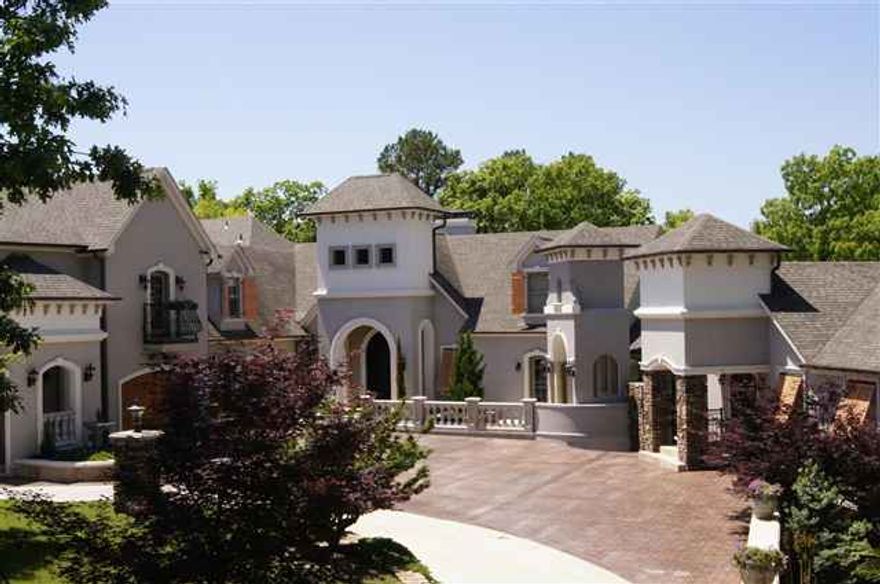 Designed with timeless elegance & sophistication, this home was built by a master craftsman & absolutely no expense was spared. Marble & granite throughout, Viking appliances, custom cabinets, pool & outdoor kitchen, 3 BR with en-suite bathrooms & 2 private guest wings, home theater, billiard room, wine cellar, solarium w/wet bar & library, master suite w/sitting area & fireplace, state-of-the-art security system.Many more details-see fact sheet. This is the premier house on the lake!Furniture/decor neg.