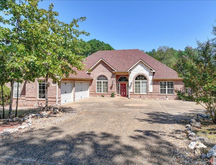 Custom Craftsman-style home with an open floor plan, cathedral ceilings, and hardwood details throughout. Features include a formal dining room, office, and a great room with fireplace and built-ins. The kitchen offers granite countertops, built-in ovens, a cooktop, and a breakfast room.  The primary suite includes a double vanity, large walk-in closet, and additional storage. Other highlights: laundry room with storage, 3-car garage with circle drive, covered patio, and large deck overlooking a wooded lot.  Located just minutes from Granada Golf Course and restaurant. Enjoy all the amenities of Hot Springs Village including golf, lakes, walking trails, fitness center, pickleball, tennis, and more.  Agents: Please schedule showings through Showing Service.