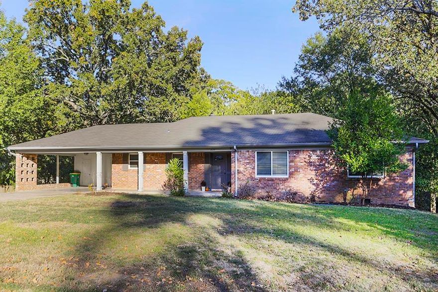 Situated on a corner lot, this 4-bedroom 3-bathroom home has excellent curb appeal! Come inside to see this cute ranch that features beautiful original hardwoods and an inviting living and dining room that is open to the kitchen. Large built-in cabinets and  a gas fireplace make this space cozy for living and entertaining. The bright kitchen has plenty of storage and granite countertops that can be used as a breakfast bar. The main level has two bedrooms that share a bath with a cool retro tile and the primary suite features two closets with a large, full bath. Downstairs, you will find a bedroom with a full bathroom that is great for guests and a large playroom or second living room that is perfect for kids or a bonus living room. This large backyard  is surrounded by trees to create privacy and is located on a fantastic, quiet street. Come see 227 Beckwood today!