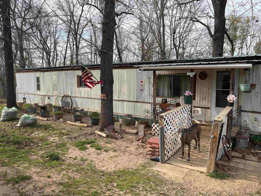 Imagine waking up to the sounds of nature on your own slice of Arkansas Ozarks.  This property has the perfect blend of space, privacy, and small town charm.  The manufactured home sits on 20 wooded acres tract.  Whether your looking for room to roam, room for livestock, gardening, or simply escape from the hustle of city life, this property delivers.  Multiple outbuildings will convey with the sale.  New metal roof in 2025.