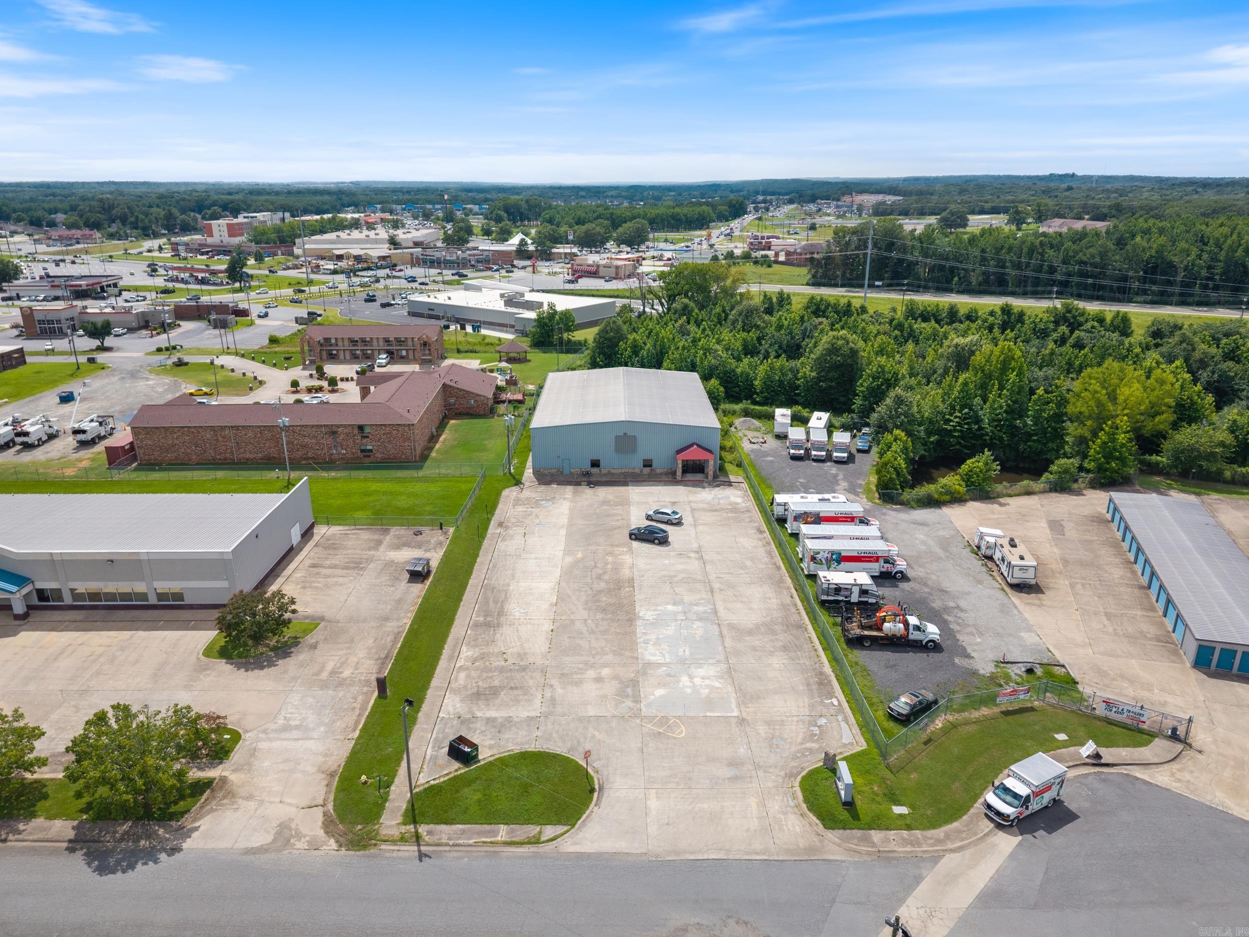 Rare 9,775 square foot commercial building on a 1-acre lot, strategically located just off Main Street in Cabot with 60 dedicated parking spaces. This expansive 115' x 85' building features 22-foot ceilings, offering a versatile open layout ideal for various commercial ventures. Previously a gym, the interior includes storage rooms and bathrooms that can be easily reconfigured for a swift buildout to suit your business needs. The building is equipped with extensive LED lighting, 120V and 220V power, fire and alarm system, and a robust heating and cooling system with comprehensive ductwork. The concrete base flooring is complemented by turf, rubber mats, and tile, providing flexibility for customization. Zoned C-3, this property supports a wide range of uses, from retail and office spaces to fitness centers or specialized facilities. Perfect for businesses seeking a high-quality, adaptable space in a prime location, this is an exceptional opportunity to establish or expand your commercial presence in the rapidly growing downtown Cabot area. Gym equipment can convey with the sale.
