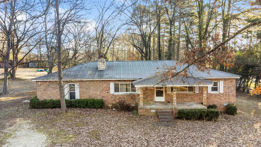 This 3-bedroom, 2-bath brick home sits on a beautiful 3.18-acre parcel, offering the perfect balance of privacy and convenience. Enjoy peaceful mornings on the front porch and unwind in the evenings on the back porch, all while taking in the quiet, open surroundings.The property truly shines with a 40x50 shop complete with electric and water already run to it—ideal for hobbies, a home-based business, equipment storage, or serious weekend projects. With over three acres, there’s plenty of room for gardening, animals, outdoor entertaining, or simply enjoying the space and freedom of country living.Located just minutes from town, this home delivers the best of both worlds: a rural feel with easy access to shopping, dining, and everyday conveniences. Listed separate as well, with house and 1 acre or shop and 2 acres.