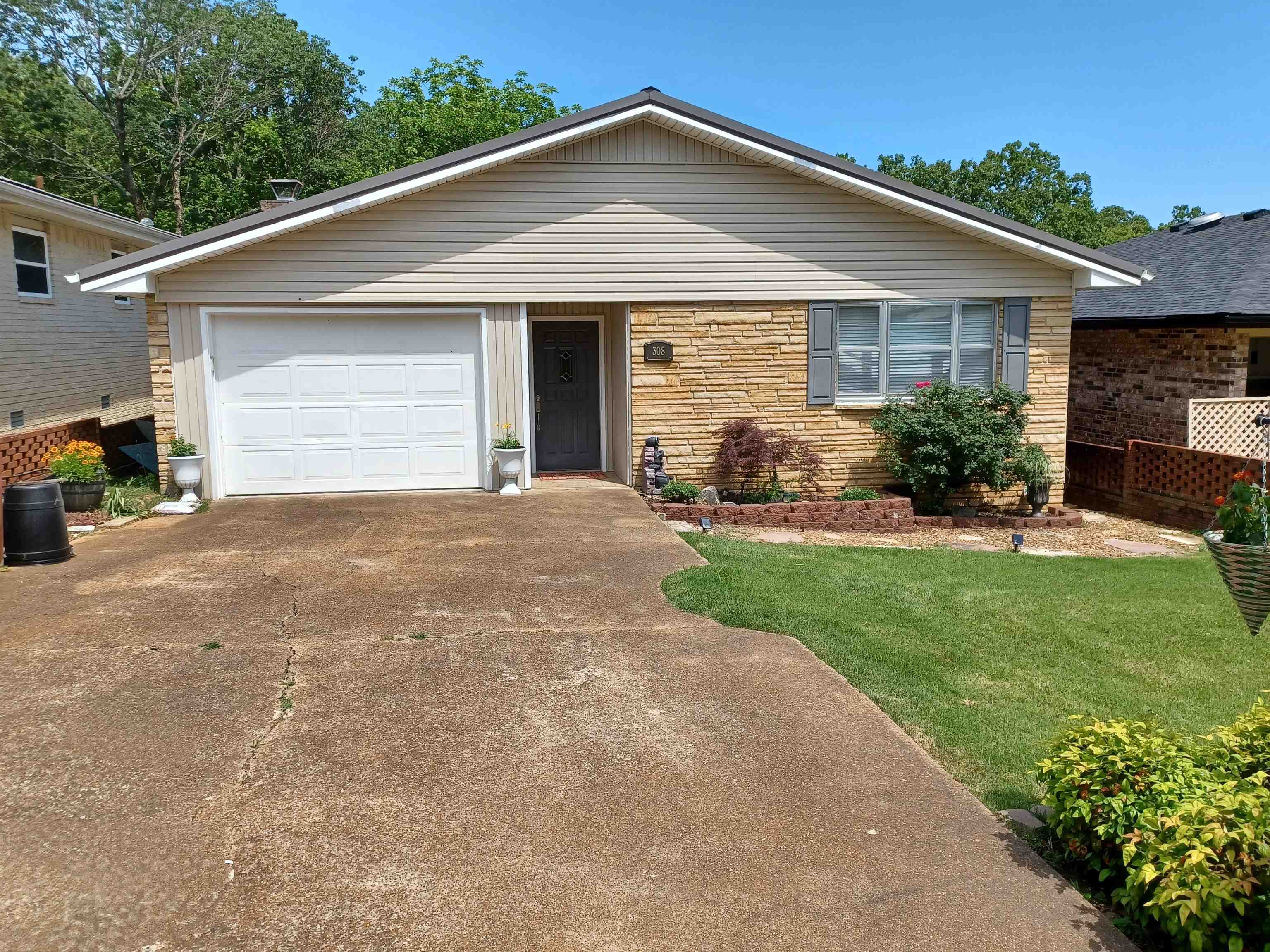 Beautifully remodeled 2-bedroom 2 bath home. Quaint 55 and older neighborhood. When you pull up to the home it has a 1 car garage with an enclosed walkway to your front door. Off the foyer is a nice size laundry room. And the hall that leads to the bedrooms and baths. This home features a beautiful sunroom. Lots of natural light. And it overlooks the park. Off the sunroom is a nice office space. The flooring has been redone with luxury vinyl flooring. The home has been freshly repainted. Master bath has been completely remodeled. The metal roof is 10 years old. Hot water tank is new. Gas log fireplace. There is an unfinished basement, that could also be a storm shelter. Carefree living, yard is mowed, there is a neighborhood pool, clubhouse, and 1/2 mile from Turkey Mountain Golf Coarse.