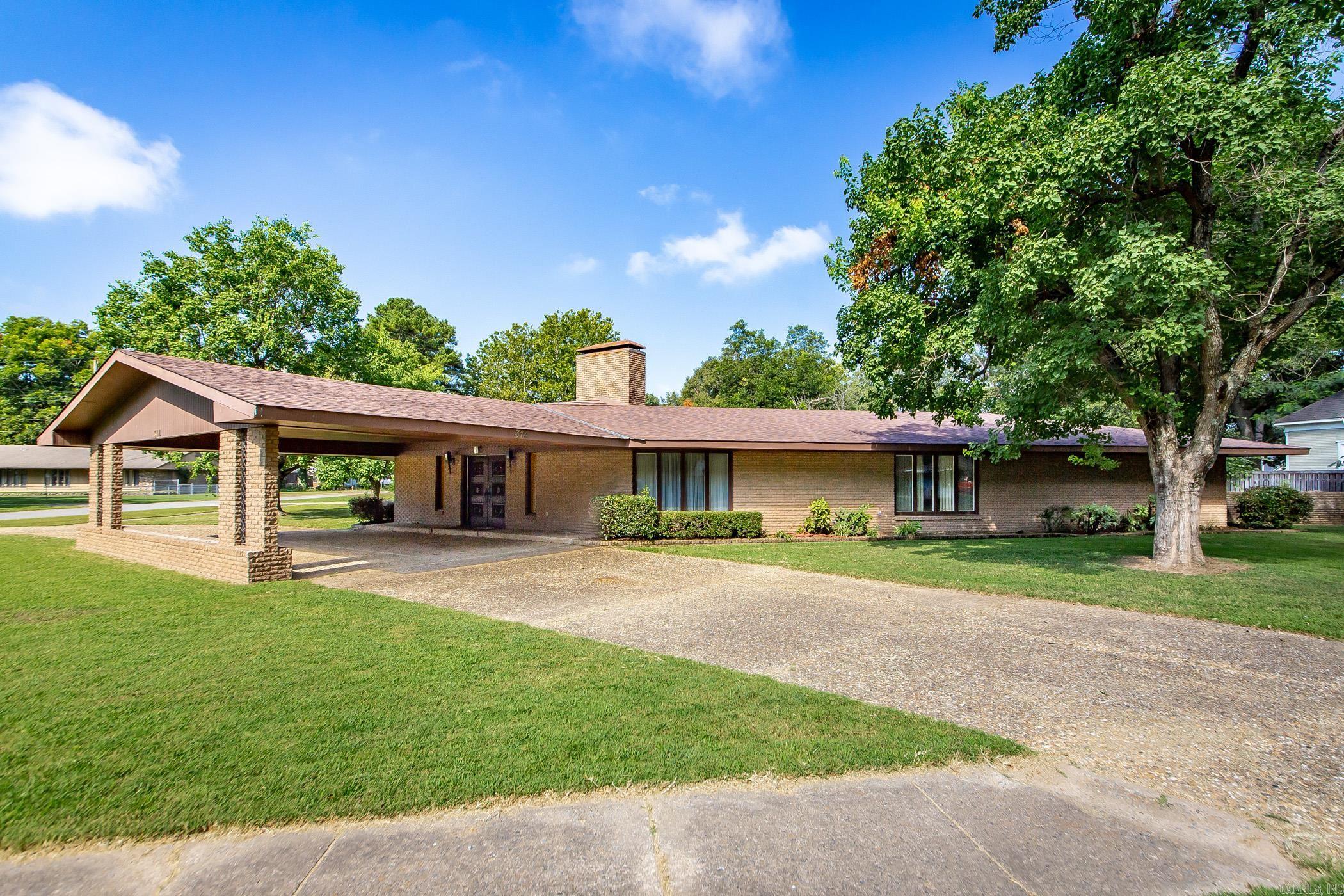 Step Back in time with this pristine Mid-Century Ranch style home. This 3 Bedroom, 3 1/2 bath home is perfect for entertaining with its open floor plan and beautiful fully fenced backyard. In addition to the home's original terrazzo tile floors and double fireplace it offers lots of storage space a two-car garage and covered carport. Schedule your showing today!