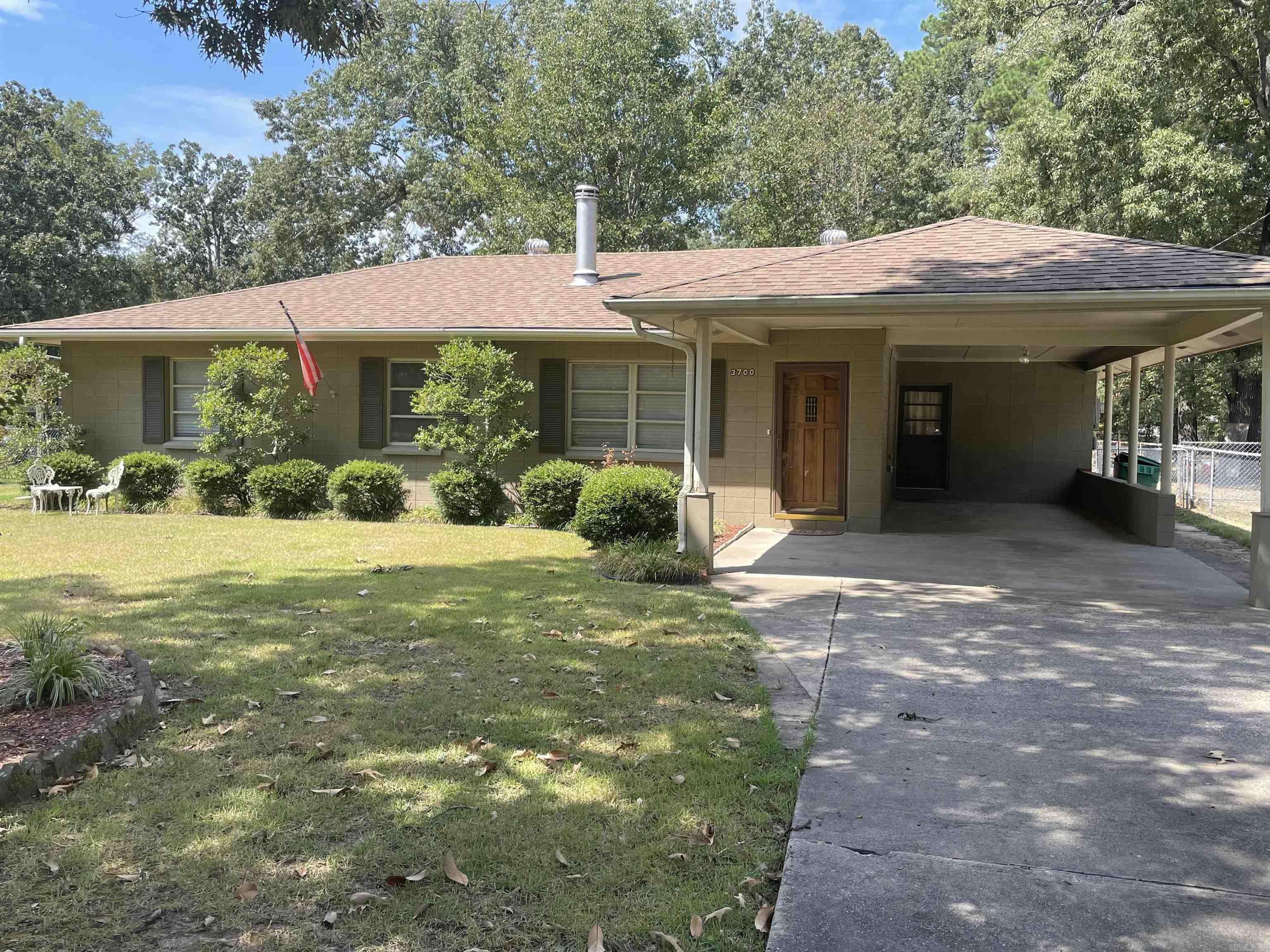 A one owner home that has been very well maintained. Neutral color throughout, carpet, luxury vinyl, window coverings remain, all appliances remain. Nice wooden deck out back, fenced garden spot, outside storage building 20X25 with extended roof on both sides for additional storage for lawn mower or garden equipment. Two drives, one that leads to the double gate to the back yard, the other a concrete driveway leading to the single carport. This property is move in ready and would make a great starter home for a couple or small family.
