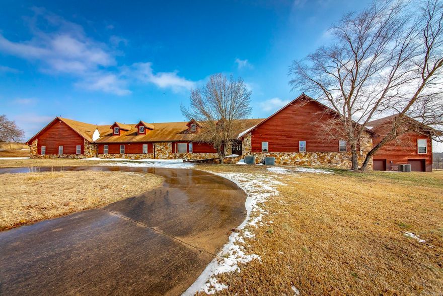 Welcome to 5415 Hwy 67—where the possibilities are endless. This unique property offers over 10,000 sq ft under one roof, including 4,000+ sq ft of garage/shop space, a main residence, and a guest house connected by a large multi-use room with built-in bar. The main home features 4 spacious bedrooms, 3 bathrooms, and extra-wide hallways and doorways for added accessibility. The guest house, built in 2019, includes a full kitchen, living room, and 2 bedrooms, each with a private en-suite bath. Situated on 17+ acres with gated access, pond, and fenced areas, this property offers privacy while remaining convenient to the interstate. Recently annexed into the City of Haskell, the front approx. 750 ft is zoned commercial with residential zoning beyond—ideal for a business and private estate. New roof available with acceptable offer. Agents see remarks.