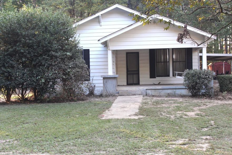Investors and flippers, this craftsman house offers incredible potential. Nestled on over seven and a half picturesque acres with towering mature pine trees, the location feels as serene as a storybook. Just minutes from shopping, this property is full of opportunity. Included is a large barn, conveyed at no value, and a mobile home at the rear of the property that may require removal. Additionally, a neighboring property with a permanently attached mobile home on over four acres (MLS 25038459) is being sold separately. Purchase both and build a small development. The property is being offered "AS IS WHERE IS," with no repairs.