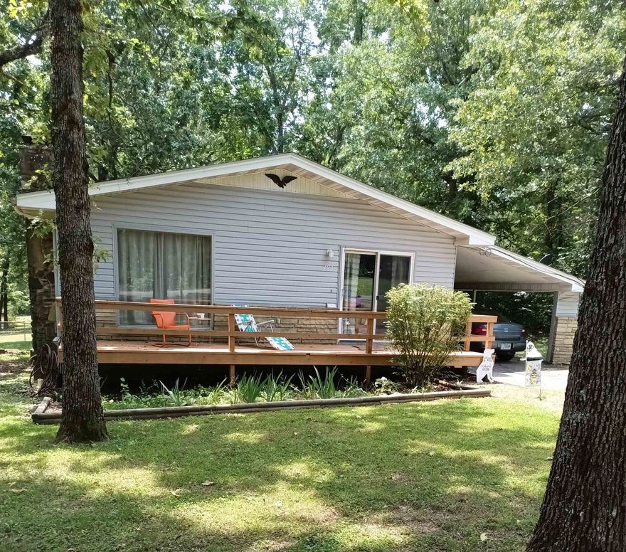 CROWN LAKE and Fisherman's Park is within walking distance from this cozy cottage bungalow in Horseshoe Bend Arkansas. Newly stained inviting porch greets guests with plenty of room to BBQ and visit. Also, another covered porch on the back of the house to sit and watch the birds and the fireflies on summer nights. Backyard is pet friendly and fully fenced. The open floor plan has a cabin feel with gas stone fireplace. Kitchen is open with an island breakfast bar seating plus eat in kitchen with large view of the front deck letting in the sunshine. Separate laundry room with washer and dryer included. Stainless steel refrigerator also stays. HVAC system has been recently updated. This cute 2bd- 1 and 1/2 bath has plenty of storage in and out. Amenities include Fisherman's Park with picnic areas, swings, large fishing dock and more right down the street. Horseshoe Bend also has a golf course, 640 acre CROWN Lake boating, water park and more. Shopping, grocery store, and anything else you need is close by. That's not all. Want an Investment opportunity? This cottage is perfect for a VRBO or AIR B&B. Call or text to schedule a showing. This one is a gem!