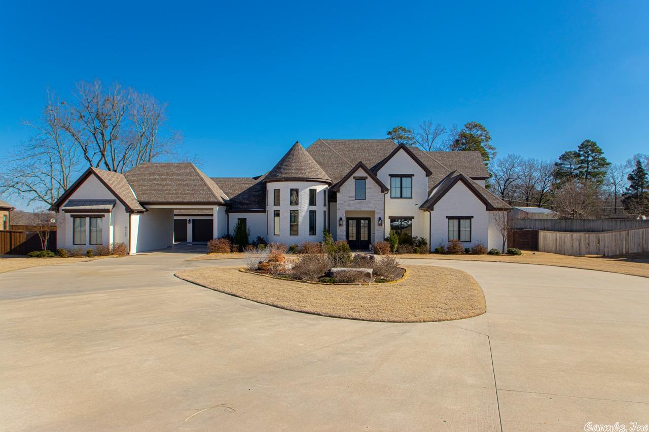 This custom built home is everything you have dreamed of and more! Situated on a 1 acre lot in West Lake Village, Saline County's premiere gated neighborhood! The floor plan lives large with open spaces, perfect for family gathering and entertaining. Upon entering, you notice the soaring ceiling, stunning lighting,and amazing curved staircase!The living room showcases a beautiful gas linear fireplace with porcelain surround floor to ceiling and power window shades.The kitchen,with porcelain countertops is every chef's dream including a 6 burner gas cooktop,wine cooler and microwave drawer in one of the islands. YES, there are 2 kitchen islands! Large pantry with auto lighting.Laundry room with sink, mud/locker area,and 2 hidden safes inside cabinets!The laundry room also doubles as a storm safe room!Master bedroom is HUGE with an en suite bathroom featuring a free-standing tub, dreamy shower and the most amazing closet you've ever seen!Also on main floor is another bedroom with large closet and private bath,office and powder room. Upstairs is 2 additional bedrooms,a bathroom and a HUGE bonus room with private bath and closet!4 car garage, single garage in courtyard has mini split!