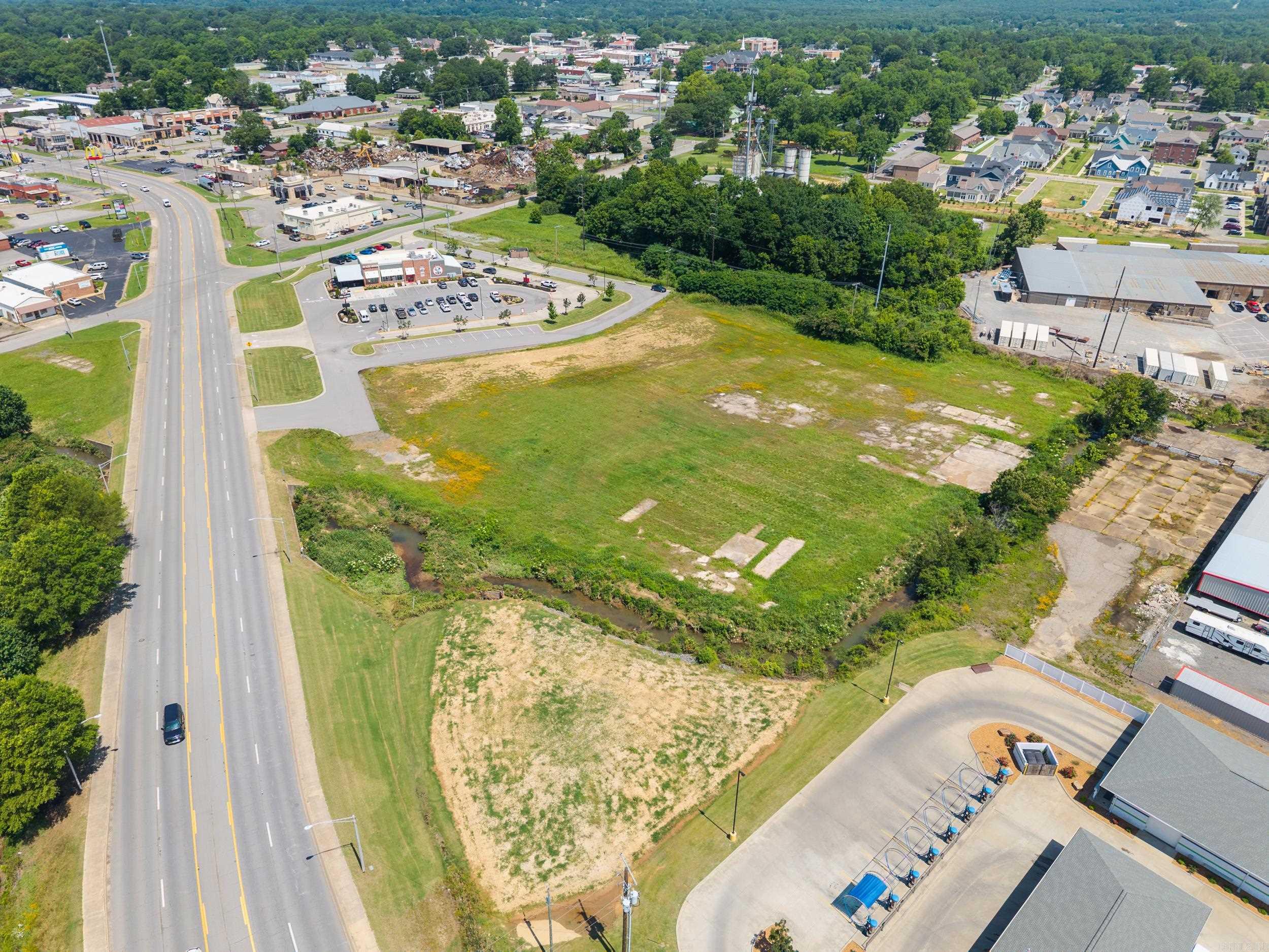 This premier 1.9-acre development site in downtown Searcy presents an outstanding opportunity for commercial investment. With approximately 300 feet of prime frontage along Beebe Capps, the property benefits from exceptional visibility and high daily traffic counts. Zoned C-4, it offers versatile development possibilities, supported by readily available utilities to facilitate efficient construction. Strategically positioned near Harding University, the Walmart Distribution Center, and other major industrial operations, the site is nestled among established businesses, including Slim Chickens, McDonaldās, Burger King, and Topicals Smoothie Cafe. Lot 2A, encompassing 1.90 acres, is available for individual purchase or can be combined with the adjacent 2.24-acre Lot 2B for expanded development potential, making this an ideal choice for visionary developers seeking a high-impact location.