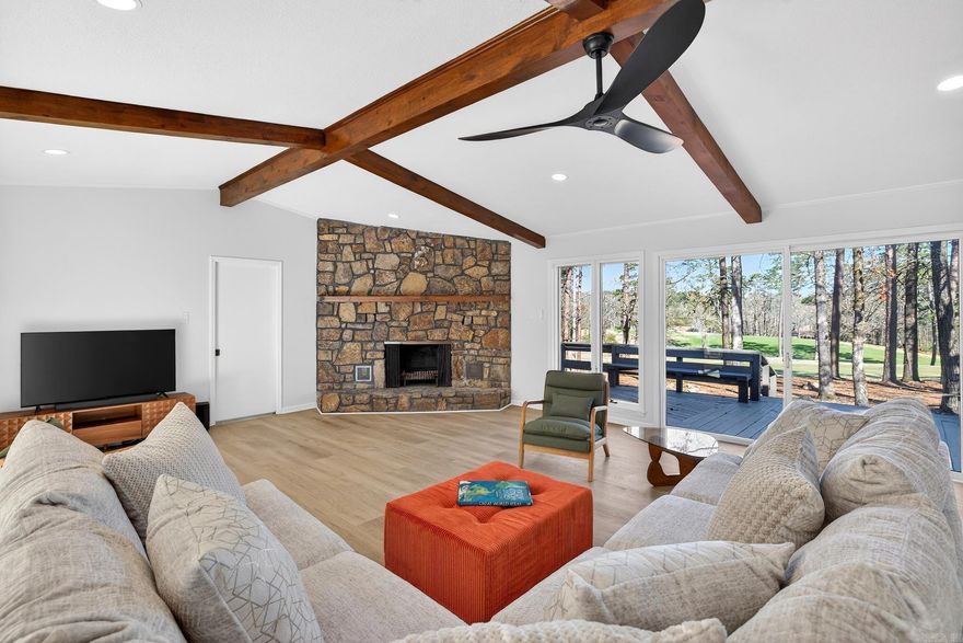 Experience the ultimate golf-course lifestyle in this stunning home overlooking the 18th fairway of DeSoto Golf Course. Perfectly situated less than a mile from the HSV West Gate, you are within walking distance to the DeSoto Club, pickleball courts, and the community pool.  The interior boasts a massive open-concept Great Room featuring vaulted ceilings with wooden beams, a floor-to-ceiling stone fireplace, and modern LVP flooring throughout. The kitchen is a chef’s dream with fully updated, soft close, custom cabinetry with elegant quartz countertops, stainless steel appliances including a 24 bottle wine fridge.  This functional split floor plan ensures privacy, featuring an oversized Primary Suite designed for relaxation with a walk-in shower and double vanity. Notably, every bedroom includes its own walk-in closet, providing exceptional storage. Outside, enjoy over 70 feet of expansive decking and a charming pergola overlooking the green.  Storage continues with an oversized two-car side-entry garage, perfect for a workshop or golf cart. Combining modern luxury with a prime location, this golf-front gem is move-in ready.