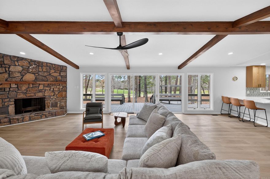 Experience the ultimate golf-course lifestyle in this stunning home overlooking the 18th fairway of DeSoto Golf Course. Perfectly situated less than a mile from the HSV West Gate, you are within walking distance to the DeSoto Club, pickleball courts, and the community pool.  The interior boasts a massive open-concept Great Room featuring vaulted ceilings with wooden beams, a floor-to-ceiling stone fireplace, and modern LVP flooring throughout. The kitchen is a chef’s dream with fully updated, soft close, custom cabinetry with elegant quartz countertops, stainless steel appliances including a 24 bottle wine fridge.  This functional split floor plan ensures privacy, featuring an oversized Primary Suite designed for relaxation with a walk-in shower and double vanity. Notably, every bedroom includes its own walk-in closet, providing exceptional storage. Outside, enjoy over 70 feet of expansive decking and a charming pergola overlooking the green.  Storage continues with an oversized two-car side-entry garage, perfect for a workshop or golf cart. Combining modern luxury with a prime location, this golf-front gem is move-in ready.