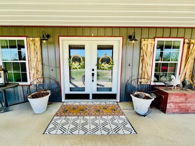 Nestled on 10 peaceful acres in Strawberry, Arkansas, this custom-built barndominium-style home blends modern living with rural charm. Built in 2020 with energy efficiency in mind, it features 5 bedrooms, 2 bathrooms, and a versatile flex room that could serve as a 6th bedroom, office, gym, or game room. The open-concept design showcases unique custom touches, while the durable metal siding and roof ensure lasting quality. Enjoy the wraparound covered porch, perfect for relaxing or entertaining. A 2-car garage includes a large storage room with access to a potential storm shelter. The split floor plan offers privacy, and the spacious master suite features his-and-her closets, porch access, and a luxurious en-suite with a rain shower and custom double vanity. Additional highlights: all-electric utilities, spray foam insulation, and abundant storage. Outside, hobby farmers will love the 40x60 shop with electricity, several outbuildings, horse pastures, pig pen, chicken coop, and kennels. A pen currently houses a friendly alpaca, mini pony, and goat (animals not included). This is country living at its finestādonāt miss your chance to tour this one-of-a-kind property!
