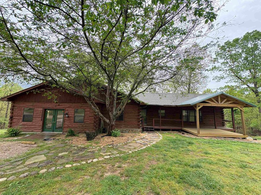 Discover the charm of this beautiful Ozark mountain log-sided cabin tucked away on 20+/- wooded acres just minutes from the famous Spring River. This spacious 3-bedroom, 2-bathroom home offers 2,169sqft of living space, featuring a split floor plan with a private primary suite that includes a luxurious en-suite bathroom complete with a Jacuzzi tub. Upon entering, you’re welcomed into the living room, with the kitchen just to the right and the dining area straight ahead—perfect for everyday living and entertaining. A large bonus room provides endless possibilities as a family room, game room, or could easily be converted into a fourth bedroom or second primary suite. Enjoy the outdoors with a beautifully maintained private yard that attracts deer, turkey, and other wildlife, plus a generous garden space ready for planting. A detached two-bay garage/shop adds extra storage and workspace includes electric. The property is accessed via a private, gated driveway, offering peace, seclusion, and the perfect country lifestyle you have been looking for!!!