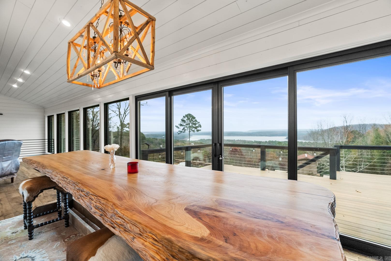 AMAZING LAKE VIEW OF GREERS FERRY LAKE Experience luxury living in this beautifully remodeled Lakeview home, where no detail has been overlooked. Pella windows showcase the breathtaking views of Greers Ferry Lake and Sugarloaf Mtn. Situated on 5 lots, this property ensures control over your stunning surroundings. Energy efficiency meets modern innovation with solar panels and a geothermal system, keeping bills remarkably low. A dramatic wall of windows spans both levels, flooding the home with natural light and maximizing views, while premium finishes throughout elevate the space to unparalleled sophistication. Don't miss the chance to own this exquisite hilltop retreat! Boat and Lift in boat slip convey at no value. Agents see remarks.